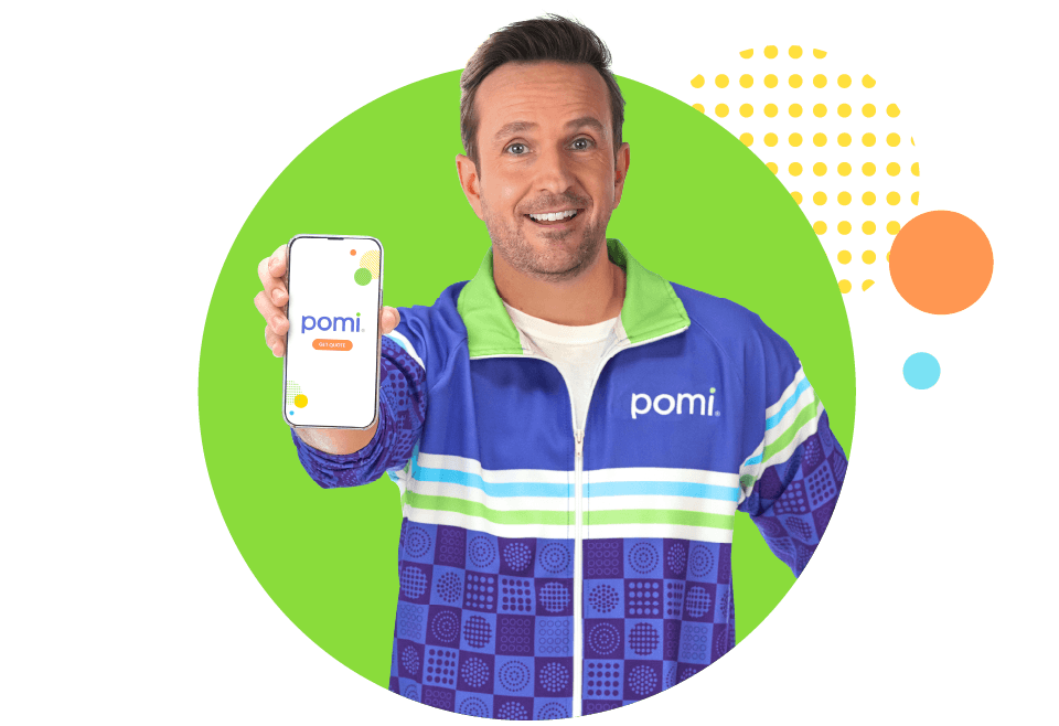 A man wearing a blue and green coach outfit, smiling, holding a smartphone.