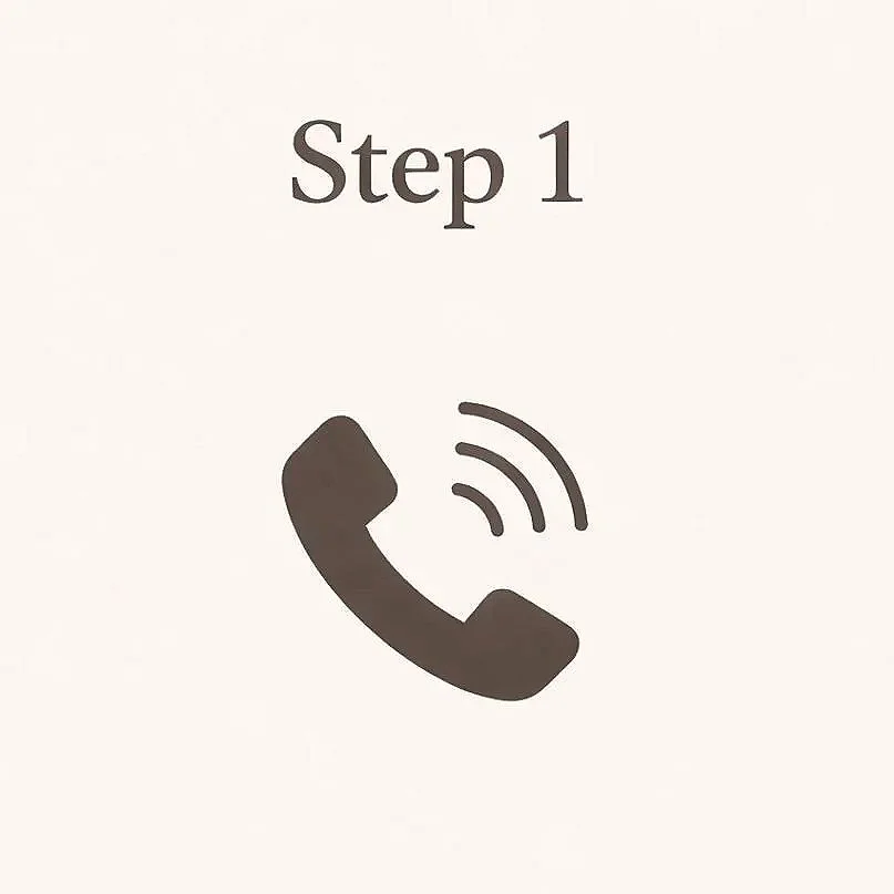 Aerial view of downtown Nashville with the AT&T building, also known as the Batman building, in the center, surrounded by modern skyscrapers and city streets under a clear blue sky.