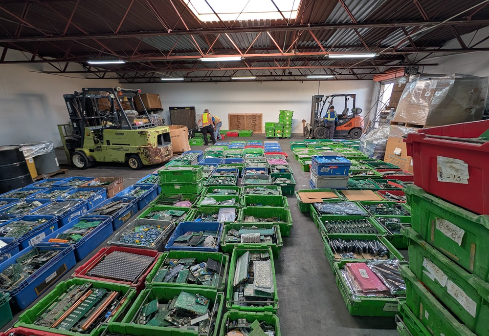 Bins of circuit boards and electronic scrap sorted by grade in the Texas Star Recycling warehouse in El Paso