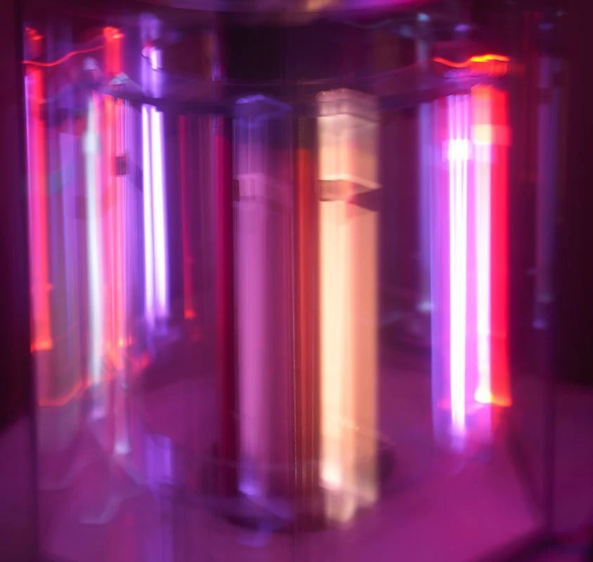 Blurred neon lights in purple, pink, orange, and red hues creating an abstract, vibrant display.