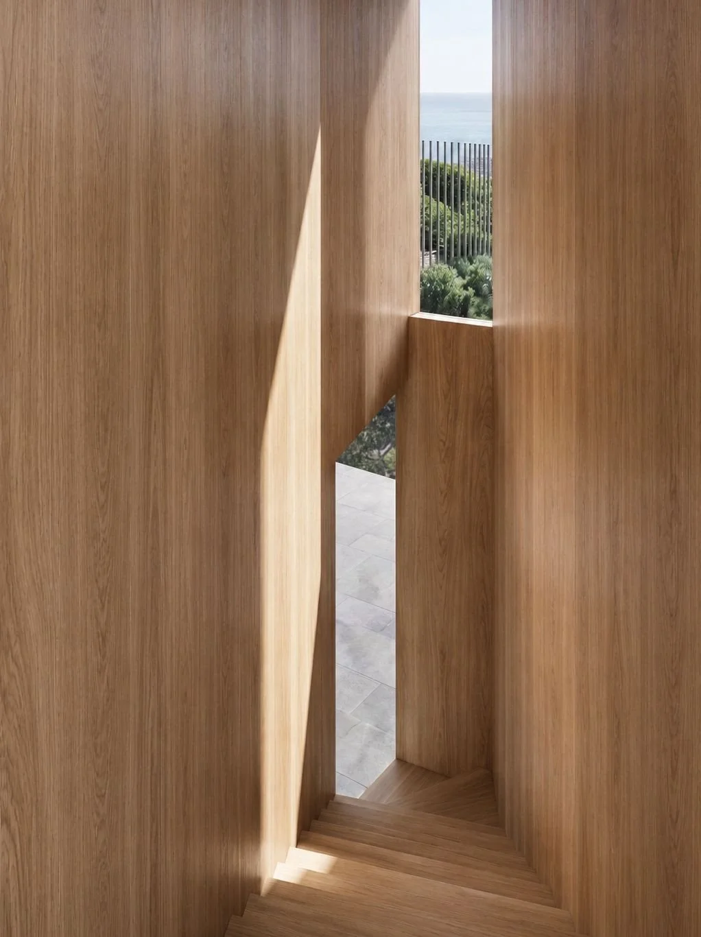 The stair at Plateau House occupies a wedge shape between the main orientation of the house and an angled side boundary. The slippage between these two alignments created an opportunity for the stair to frame a unique view of the roof garden and hori