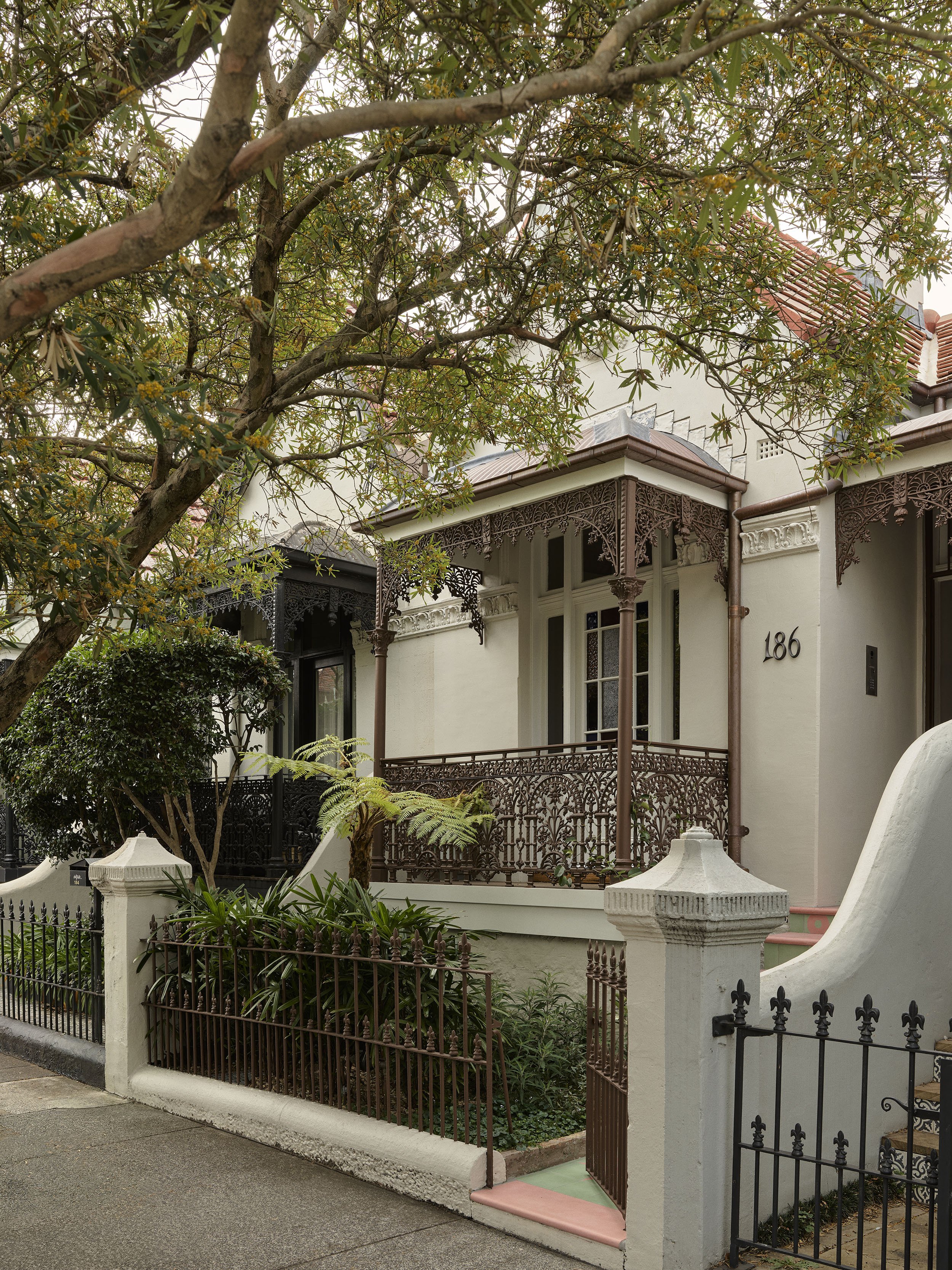 The heritage restoration of the front of an eastern suburbs Woollahra heritage house by Muci Architects. New copper guttering and roofing and porters liquid bronze paint.