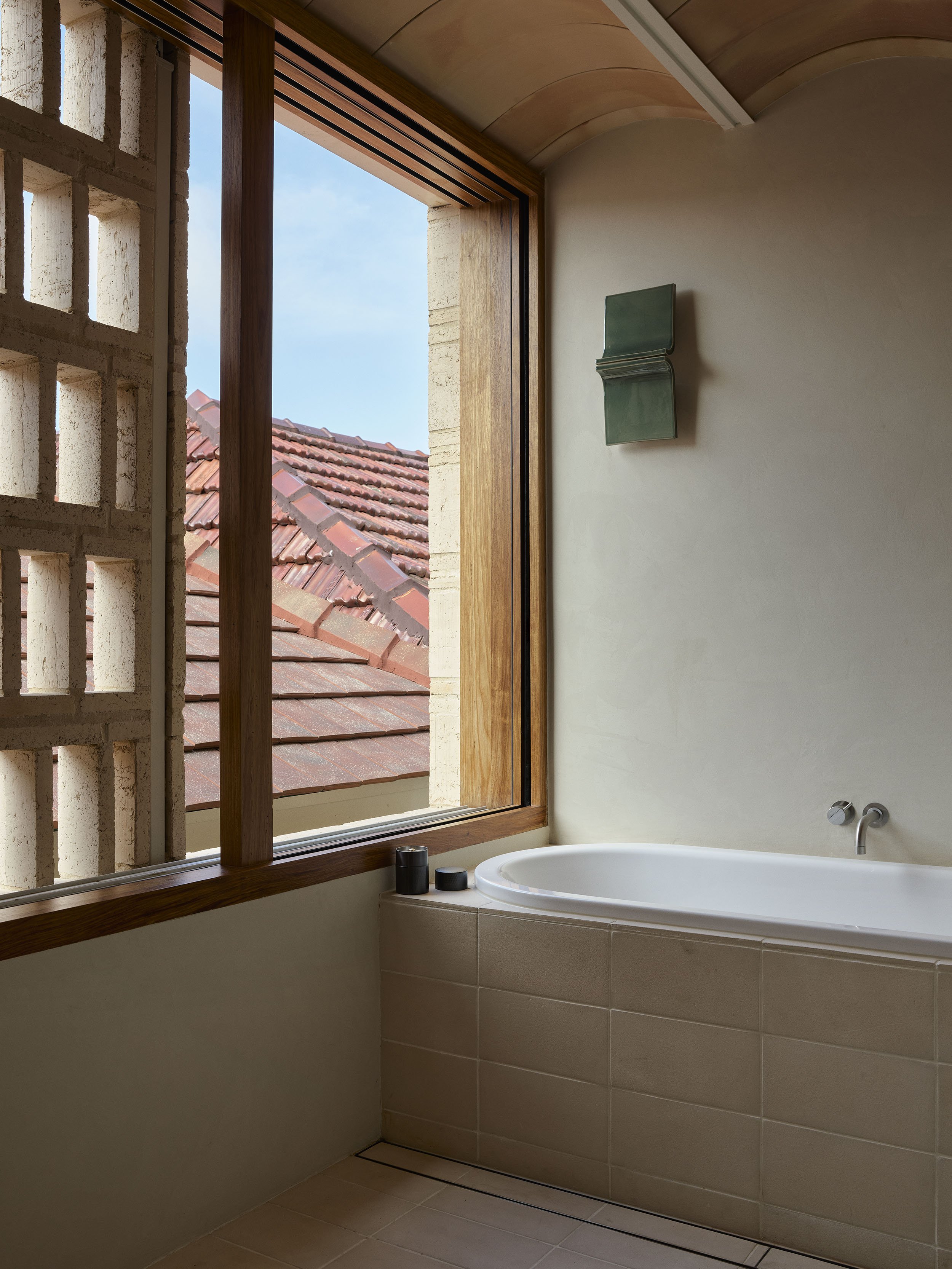 The bath with a view over rooftops at the woollahra renovation by Muci architects.