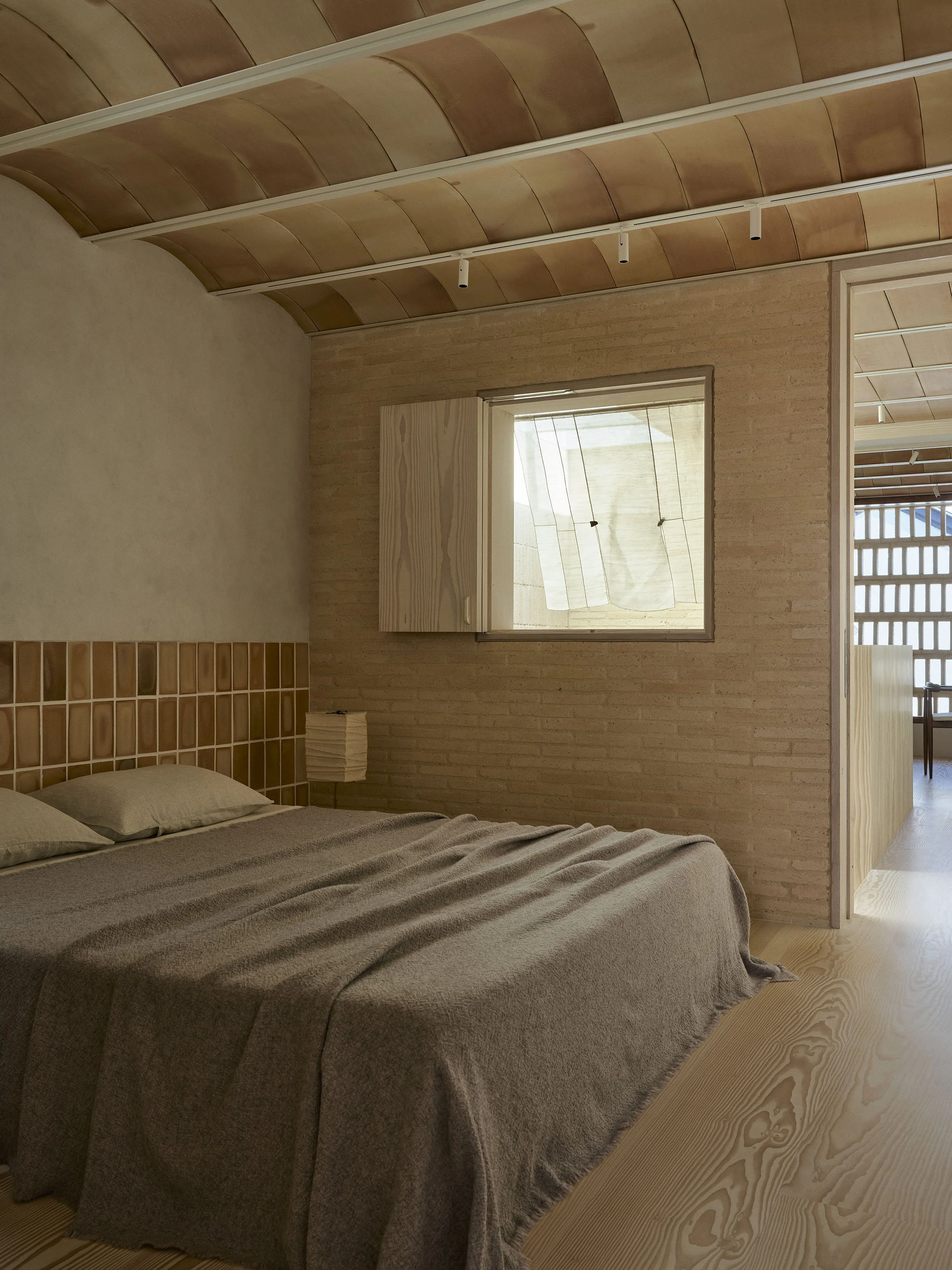 The main bedroom in the Sydney terrace renovation by Muci architects in woollahra. There is a Dinesen Douglas fir floor and teracotta tile bovedilla ceiling.