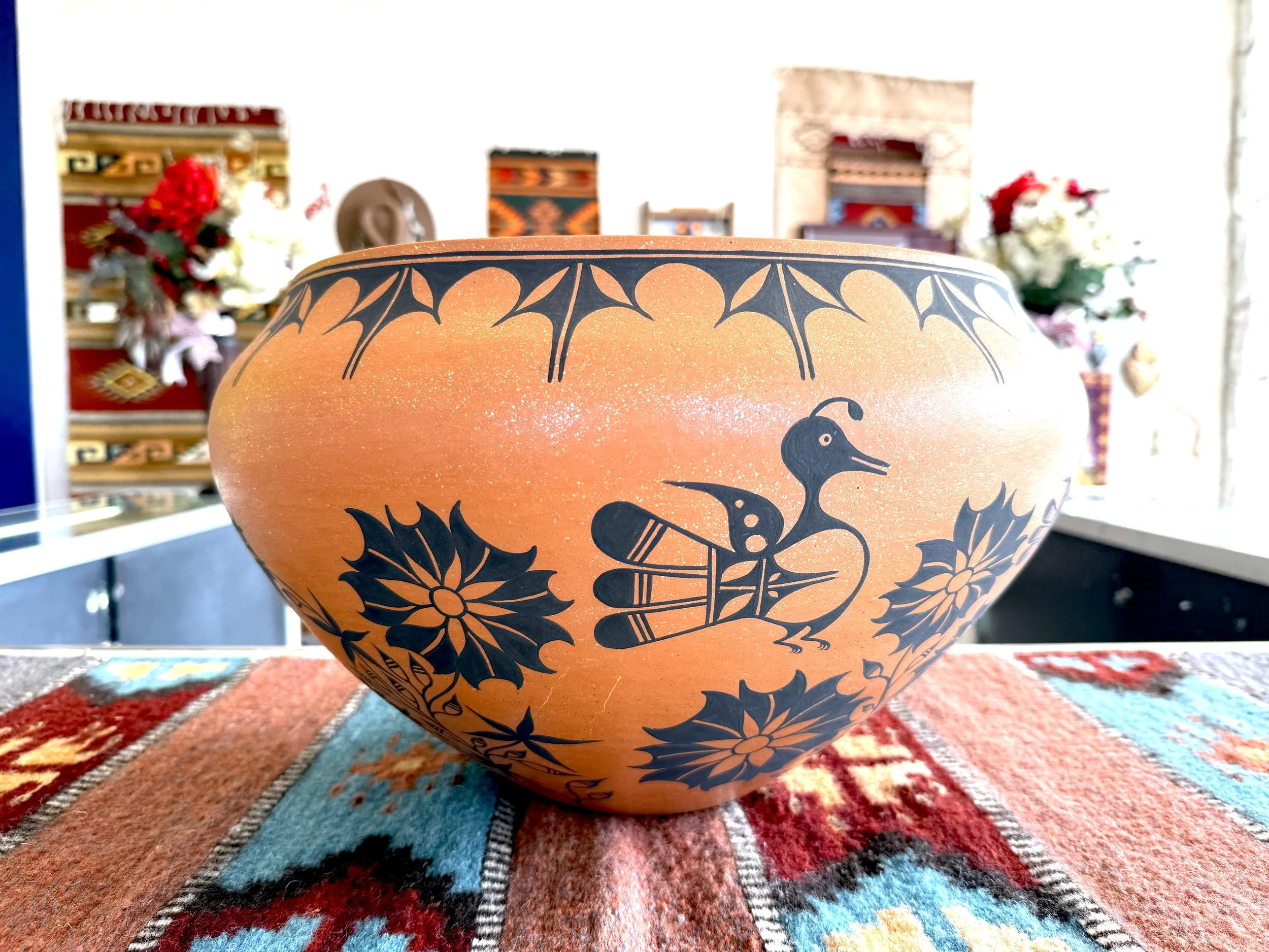 Wonderful large authentic Native-American vase handcrafted, displayed on a colorful rug.