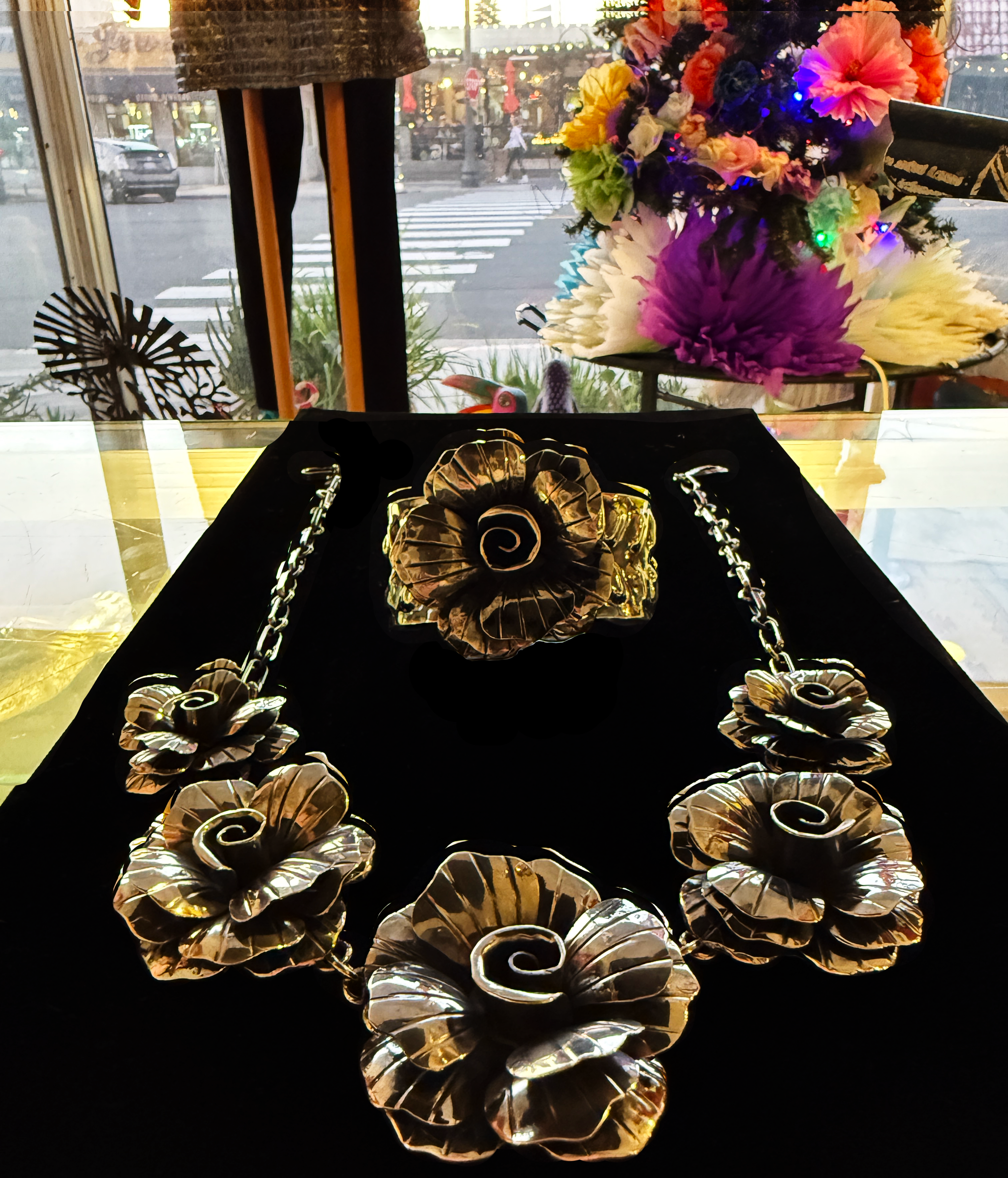 Beautiful large floral patterns on a large silver necklace and bracelet.