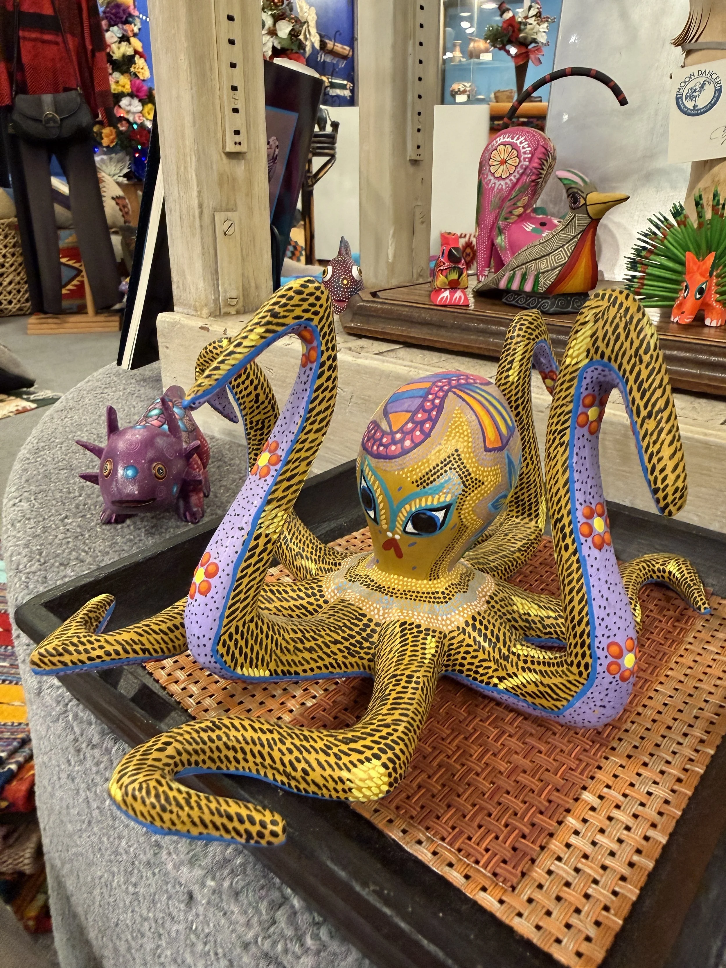 Colorful, painted wooden carving of an octopus with a mosaic-like face. Hand-carved in the Oaxacan style.