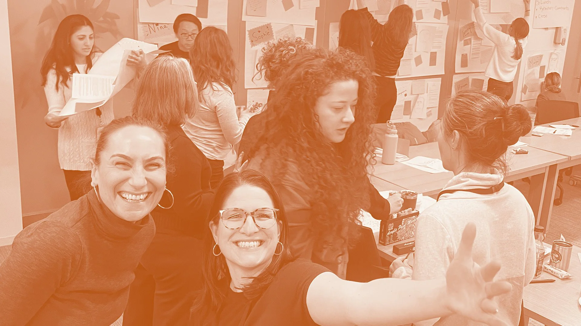 Stacy Berger and Jenna Shapiro appear smiling at the bottom left of the image, in the background a group of people engage in conversation in small groups