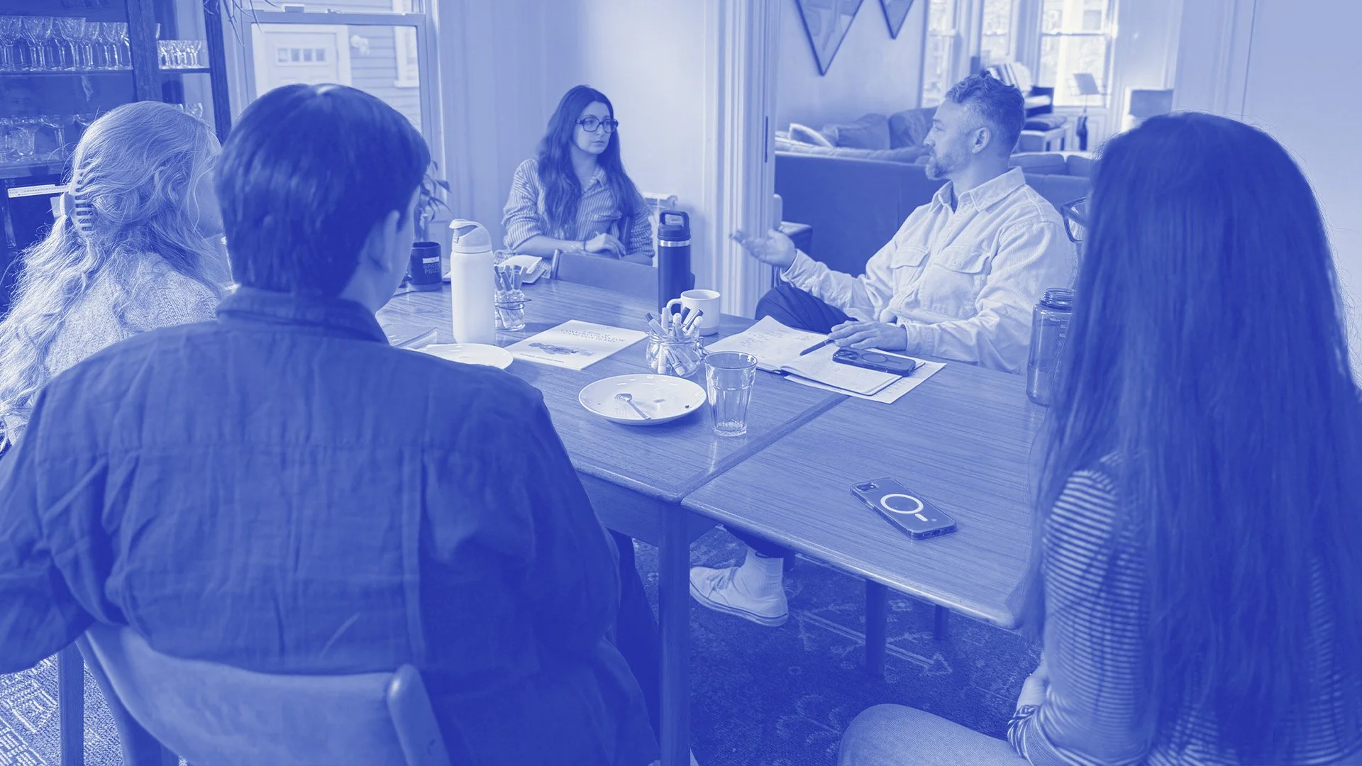 A group of people at a conference table in conversation