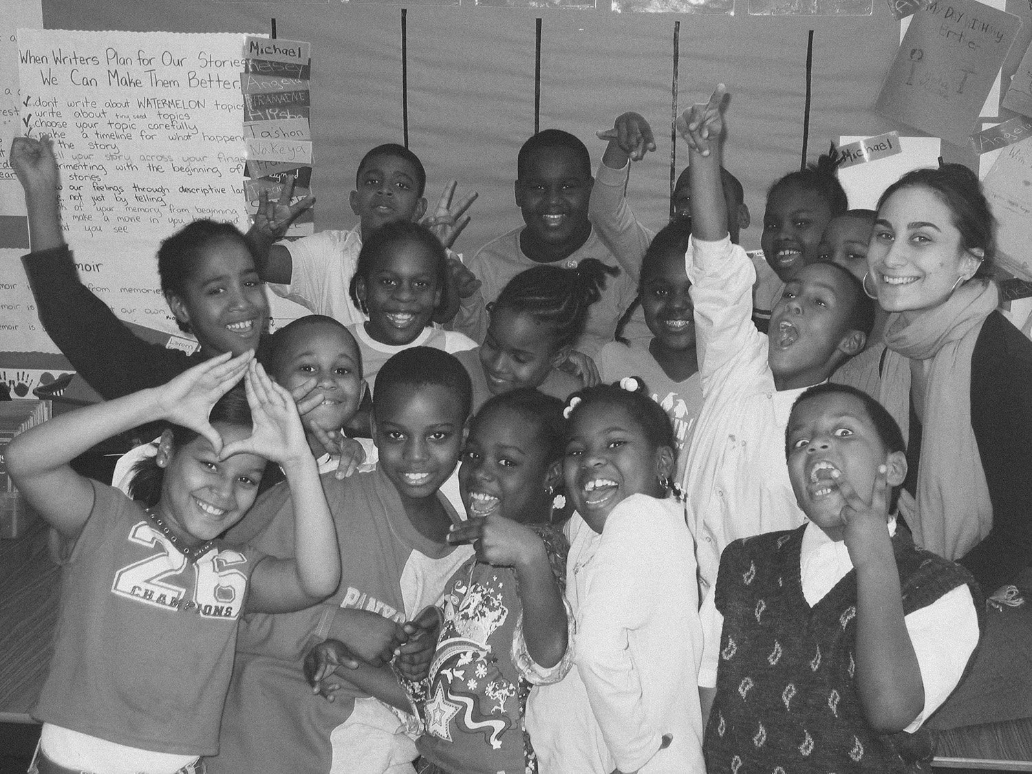 Jenna Shapiro stands with a group of students in a classroom setting
