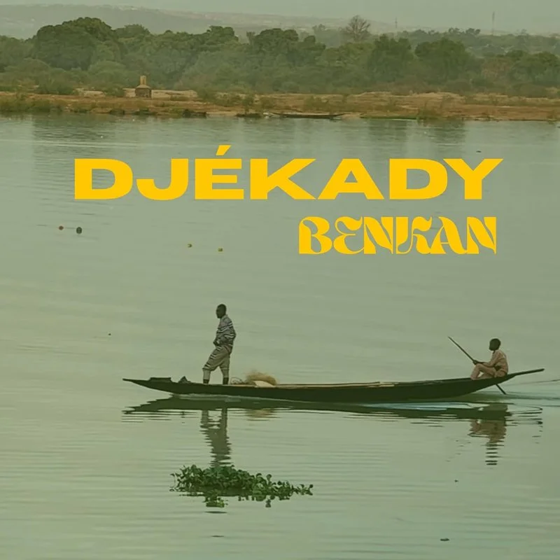 Two people in a boat on a calm body of water with green vegetation in the background. Large yellow text overlays the image that reads 'DJÉKADY BENZAN'.