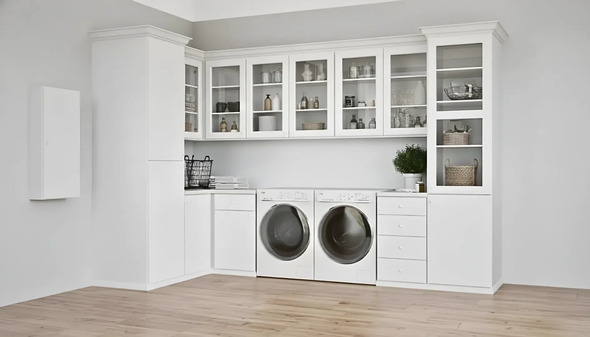 White laundry room with front-loading washer and dryer, white cabinets, and light wood flooring.