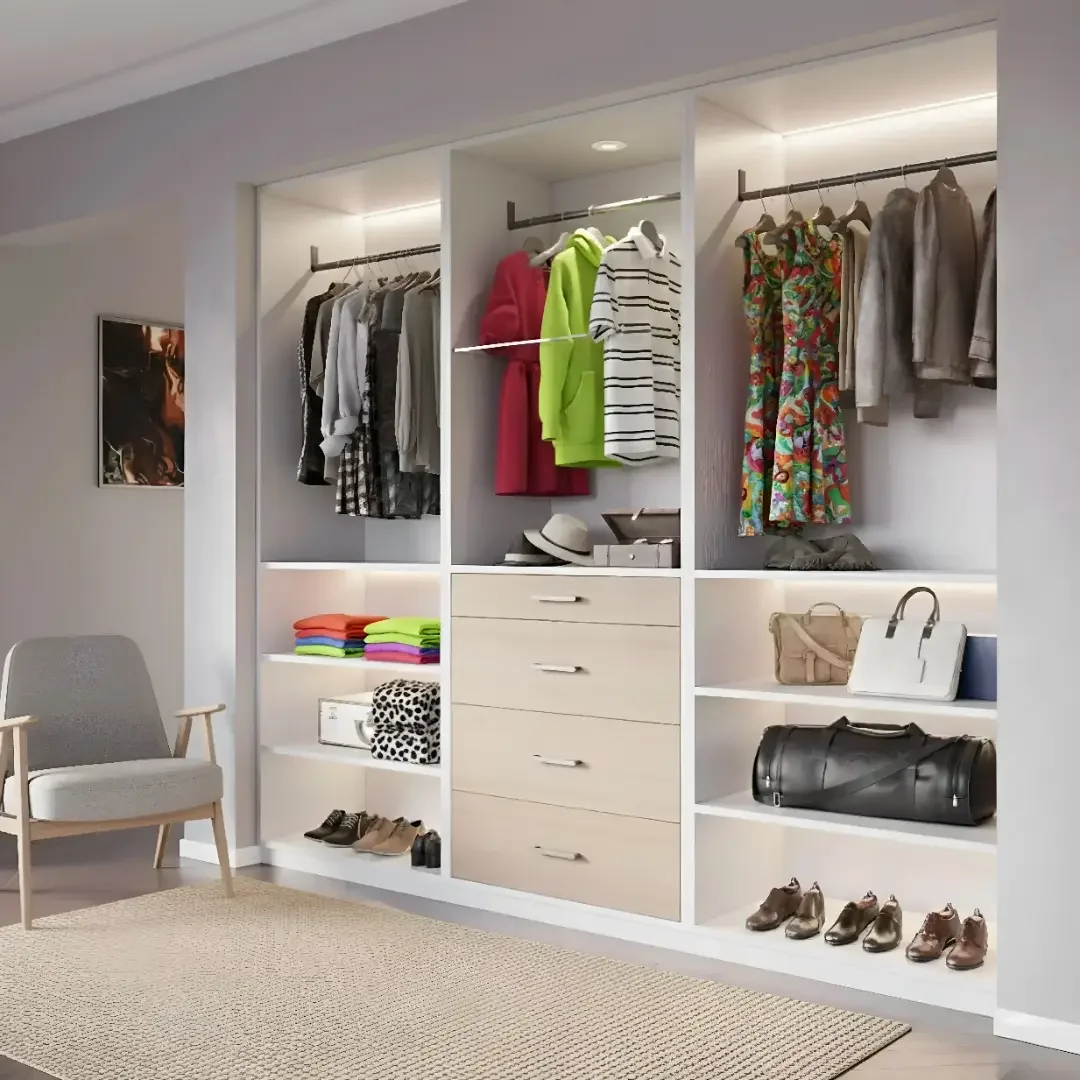 Open closet with hanging clothes, folded towels, shoes, handbags, and hats in a modern bedroom.
