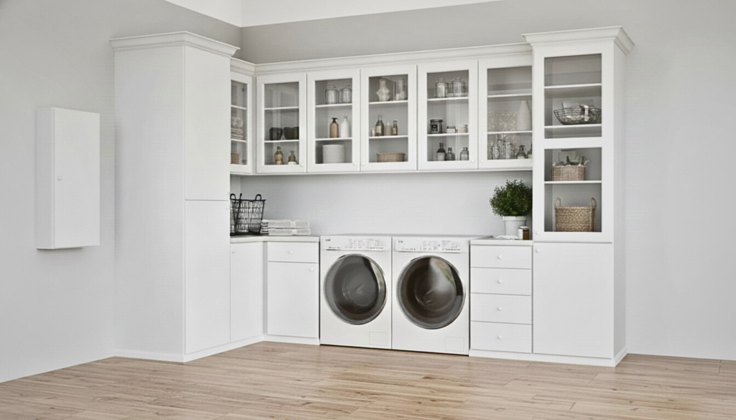 A modern laundry room with white cabinets, a front-loading washing machine and dryer, and wooden flooring.