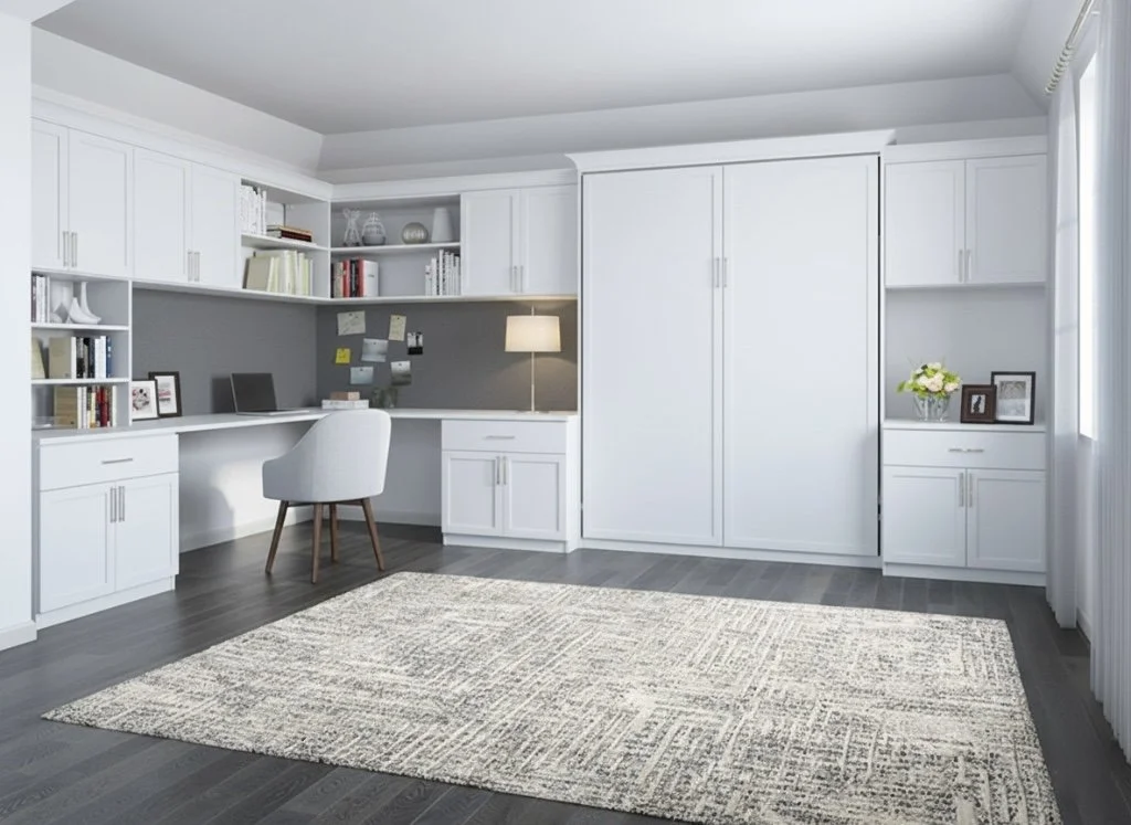 A modern home office with white built-in cabinets, a gray desk with shelves, a white office chair, a gray wall with notes, a desk lamp, a vase with flowers, and a patterned rug on dark hardwood floor.