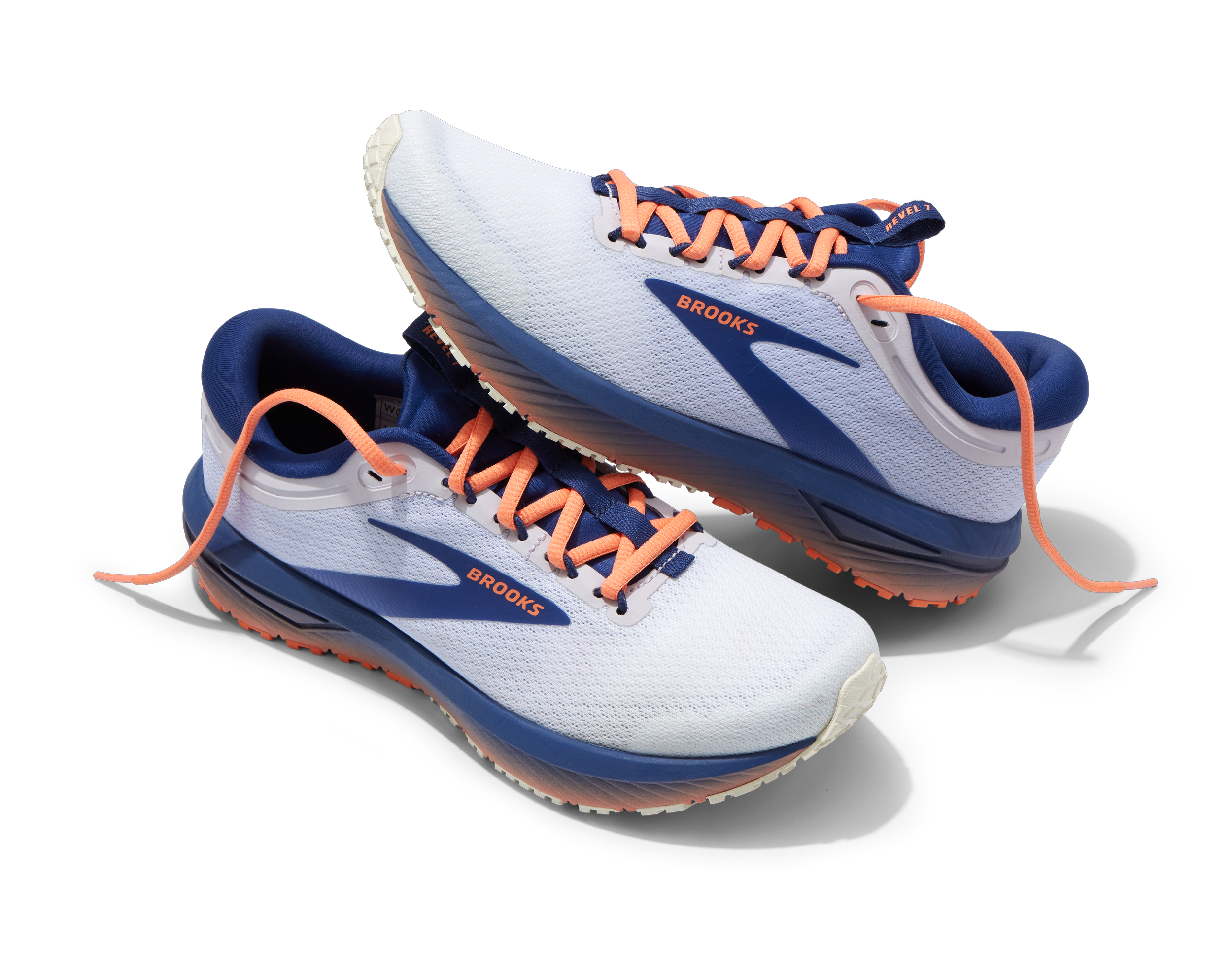 Pair of white and blue Brooks running shoes with peach laces on a black background.