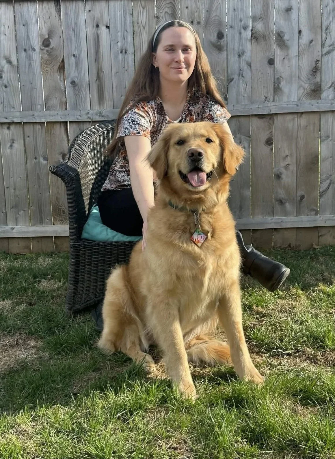 Therapist sitting with her golden retriever, representing a warm and welcoming counseling environment
