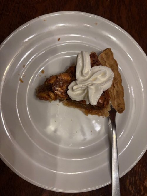 A slice of peanut butter pie with whipped cream