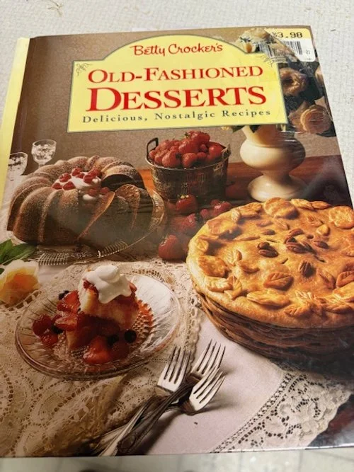 Cover of Betty Crocker's Old-Fashioned Desserts. Cover illustration includes a bundt-style cake, a slice of strawberry shortcake, and a double-crust pie. A tattered $3.98 price tag is visible at top right.