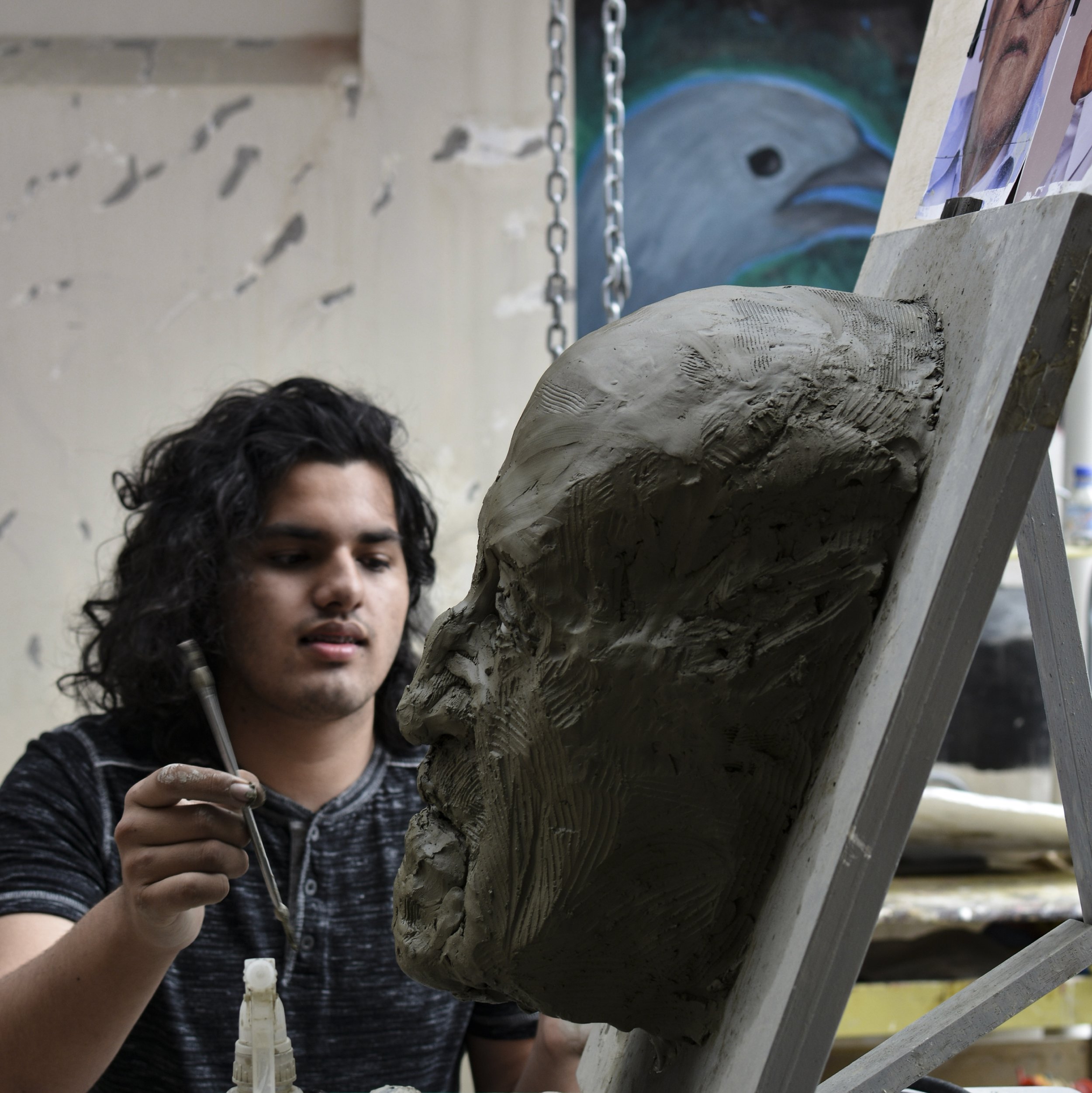 Ruben working on a portrait of his grand father. 2018