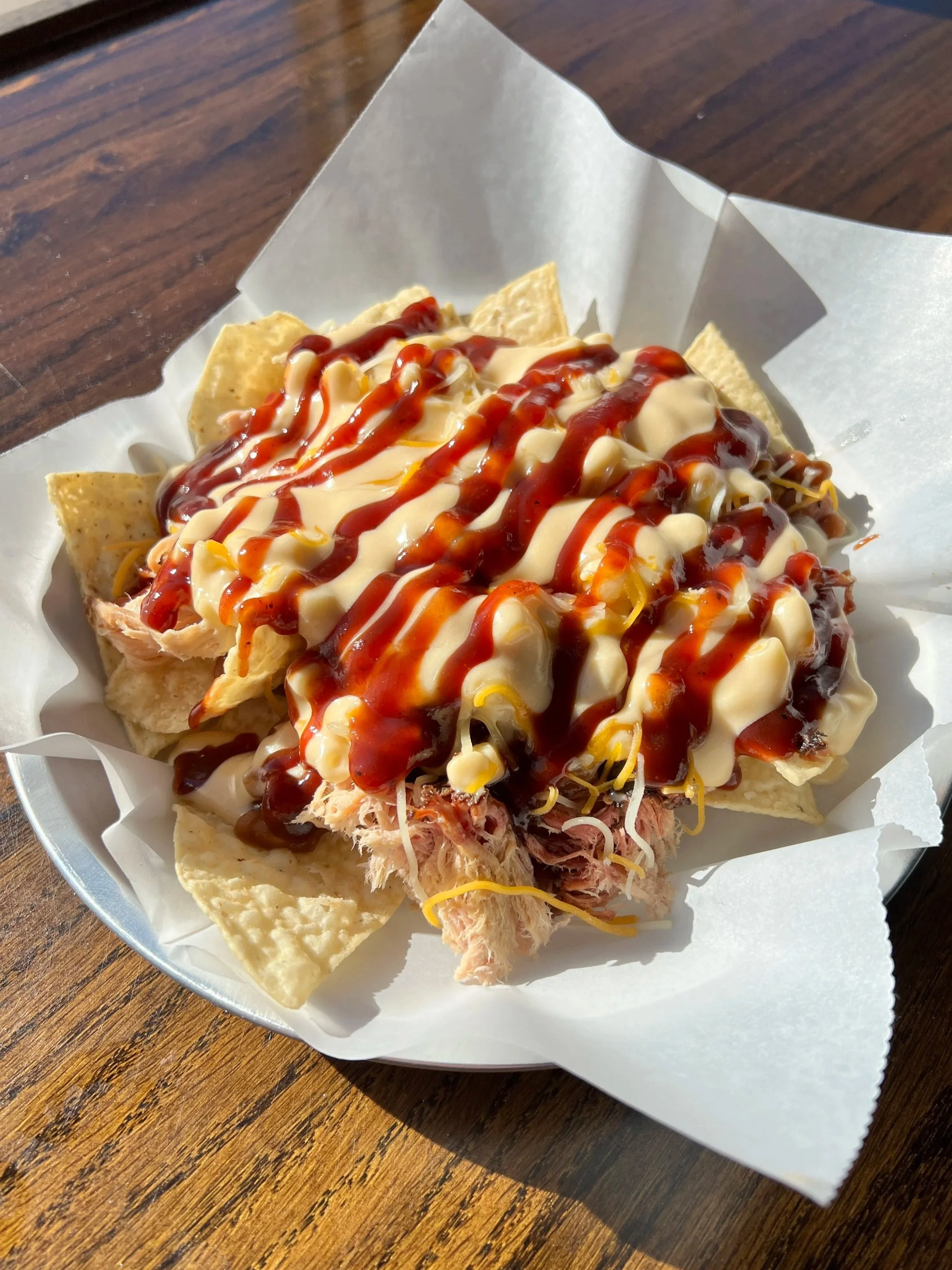 Shredded pork, chips, cheese, and barbecue sauce.