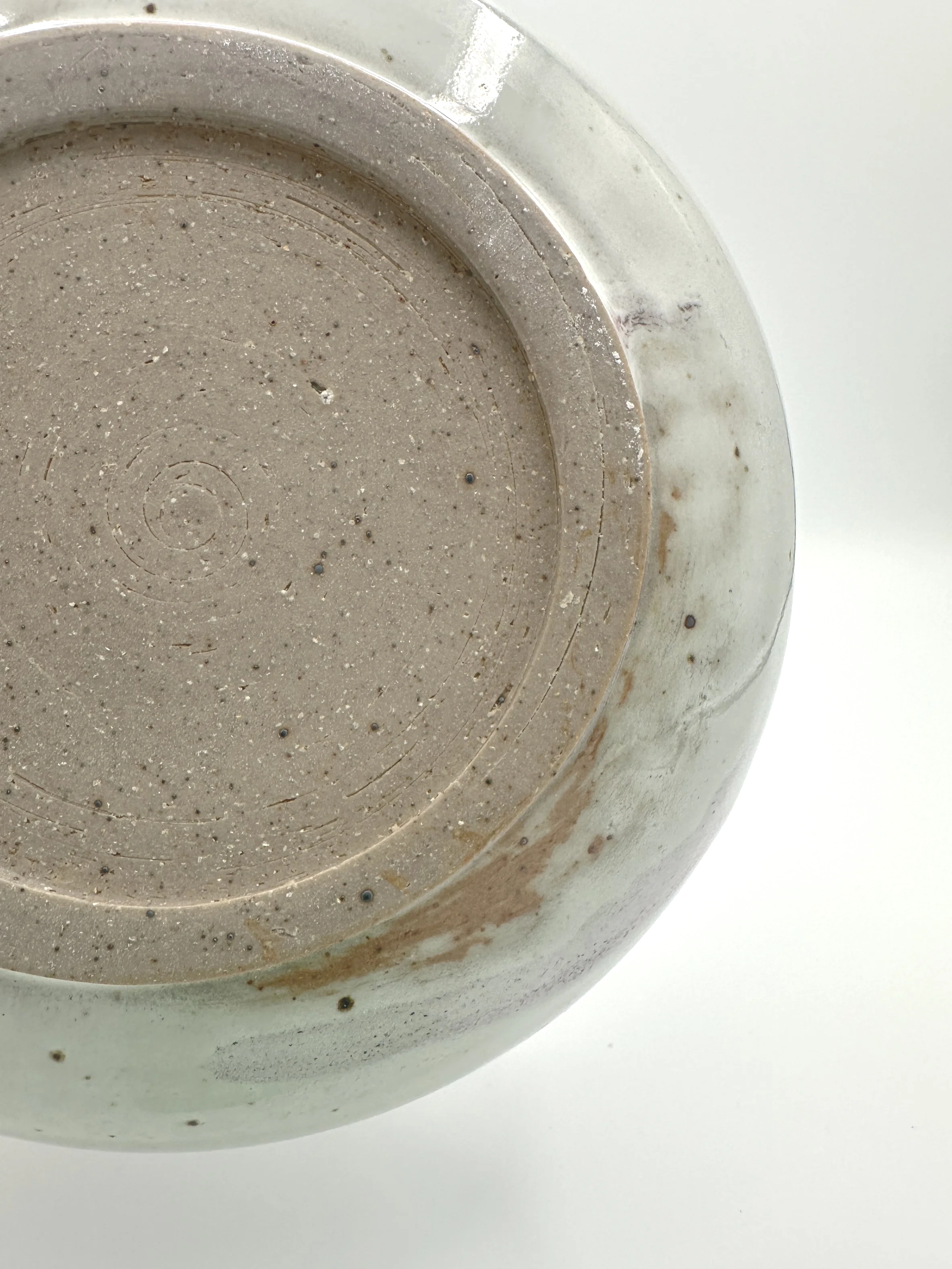 bottom of handmade stoneware ceramic planter with glaze imperfections