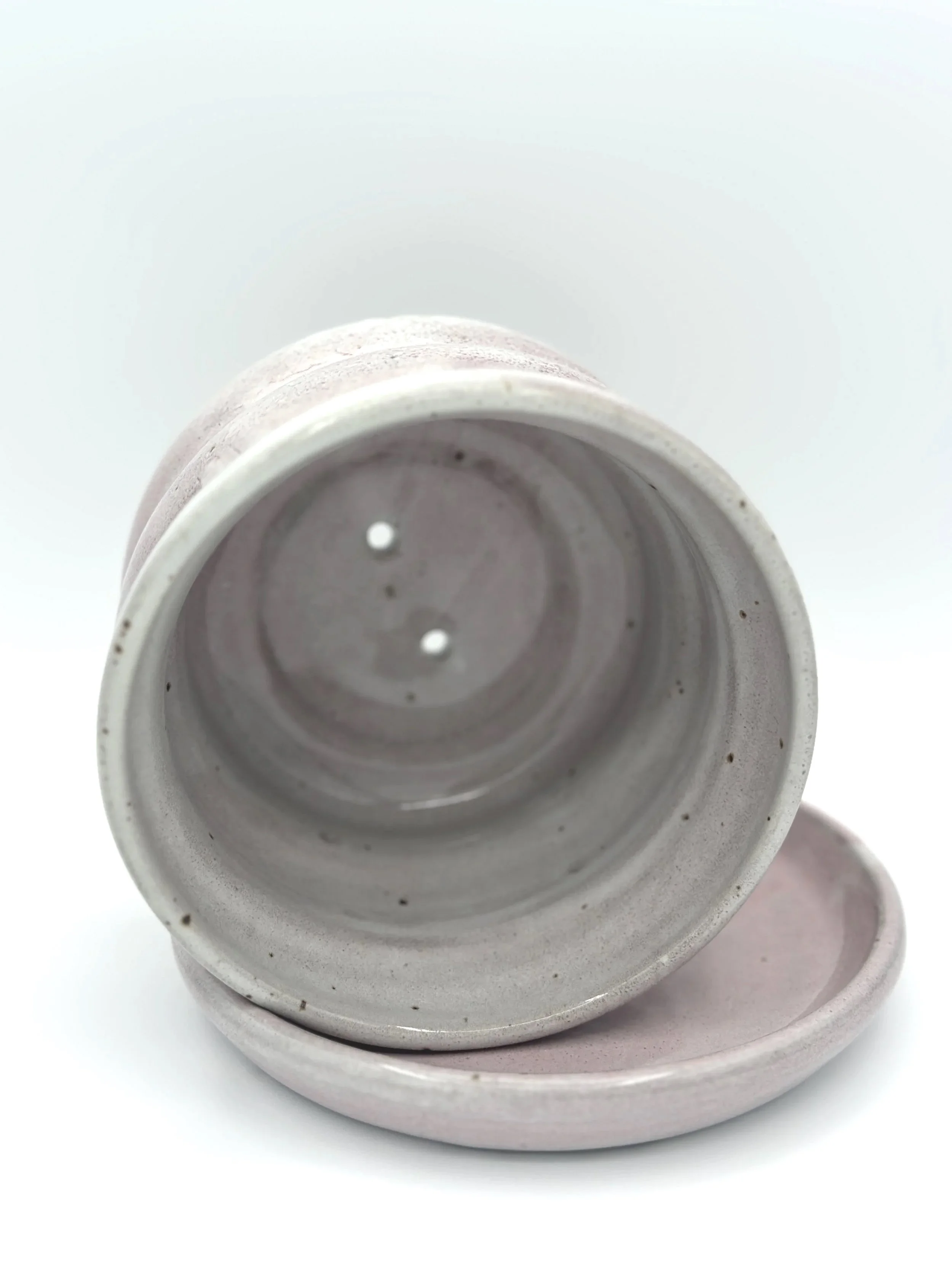 handmade stoneware ceramic bubble planter with 3 waves and a tray in glossy lavender, mauve, pink and grey glaze held by a manicured hand