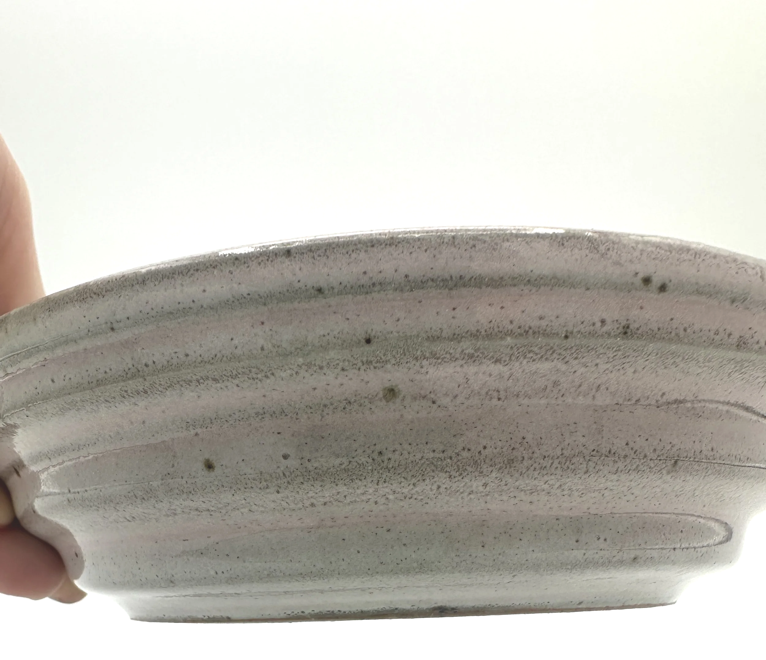 handmade stoneware ceramic planter tray close up of stepped planter tray in pinkish grey shiny glaze