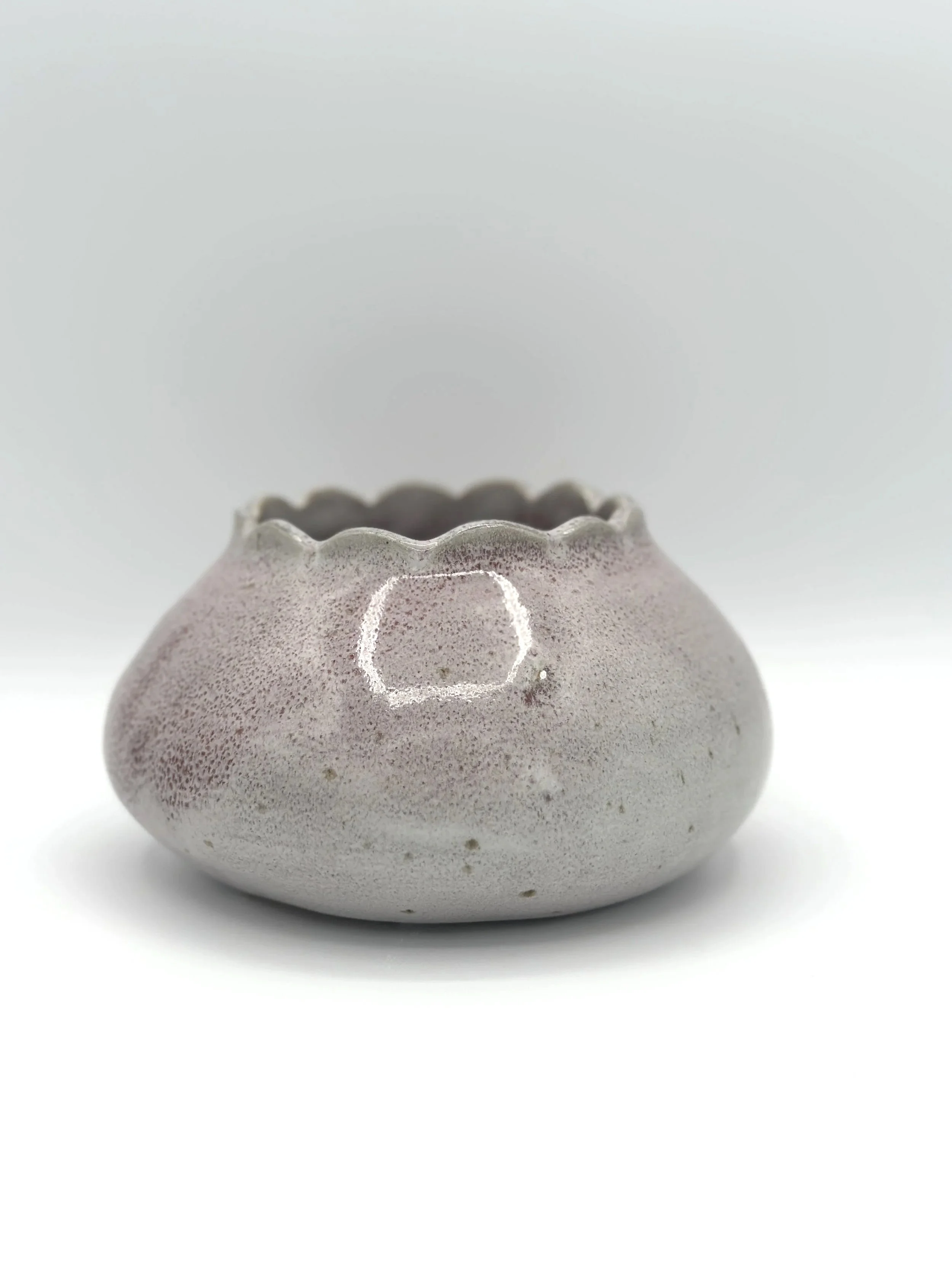 handmade stoneware ceramic bud vase in glossy lavender, mauve, pink and grey glaze with scalloped rims