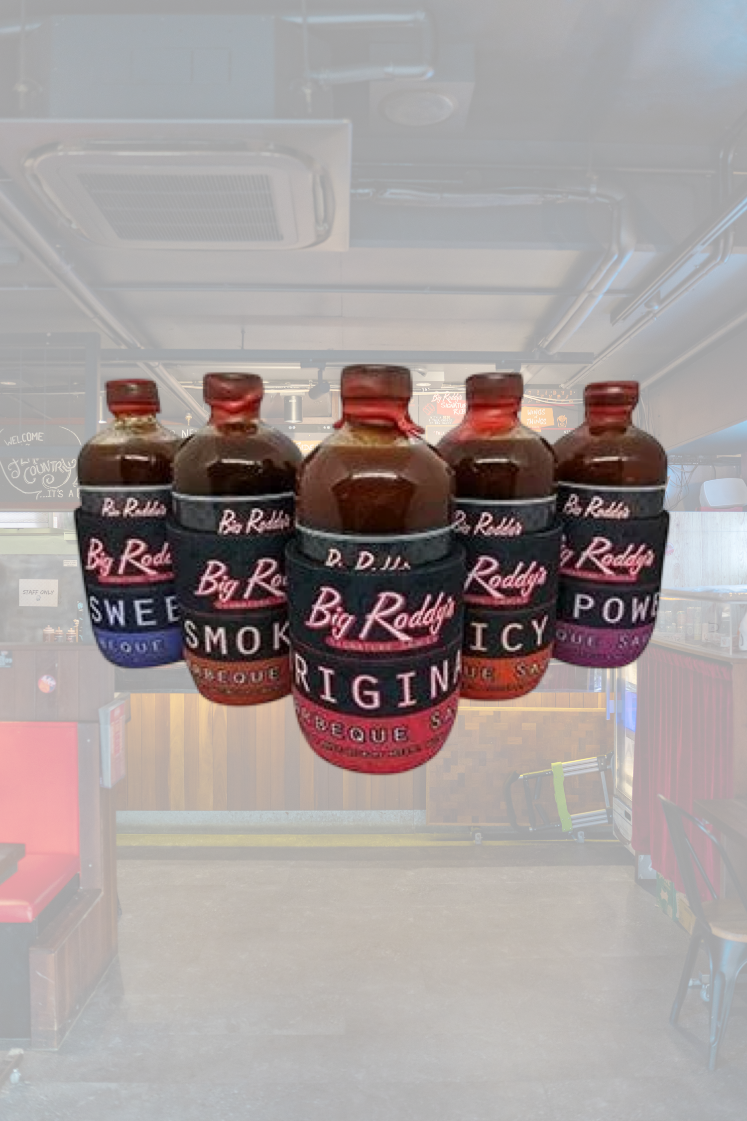 Six bottles of Big Roddy's house-made signature barbecue sauces in their restaurant or store.