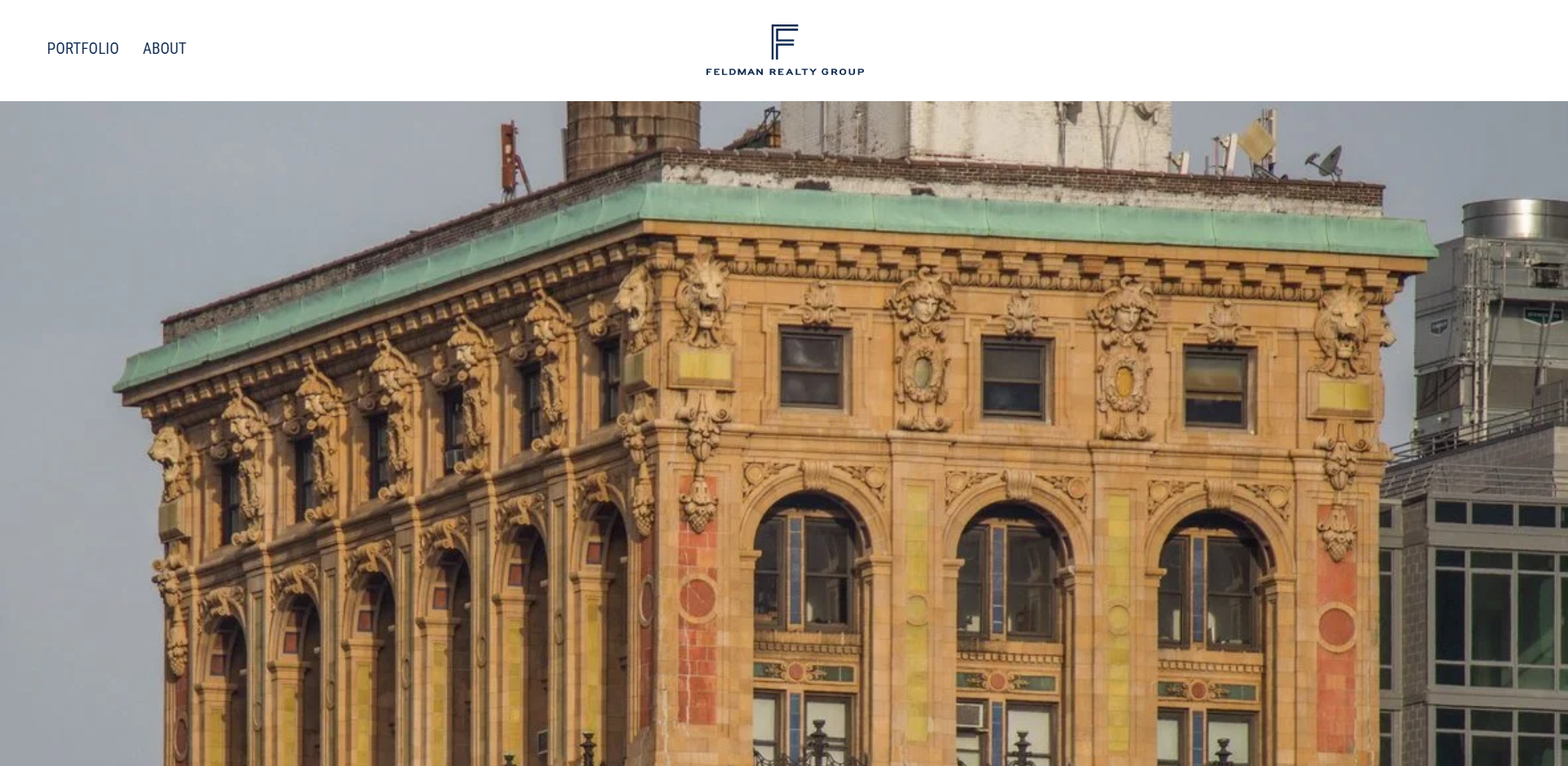 Close-up of a historic ornate building with decorative lion head sculptures and detailed architectural elements on the facade.