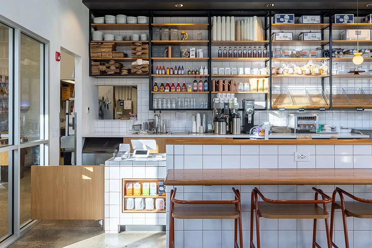 goldsteins-bagels-cafe-check-out-counter-orange-half-hurdle-barstools-detail-landscape.jpg