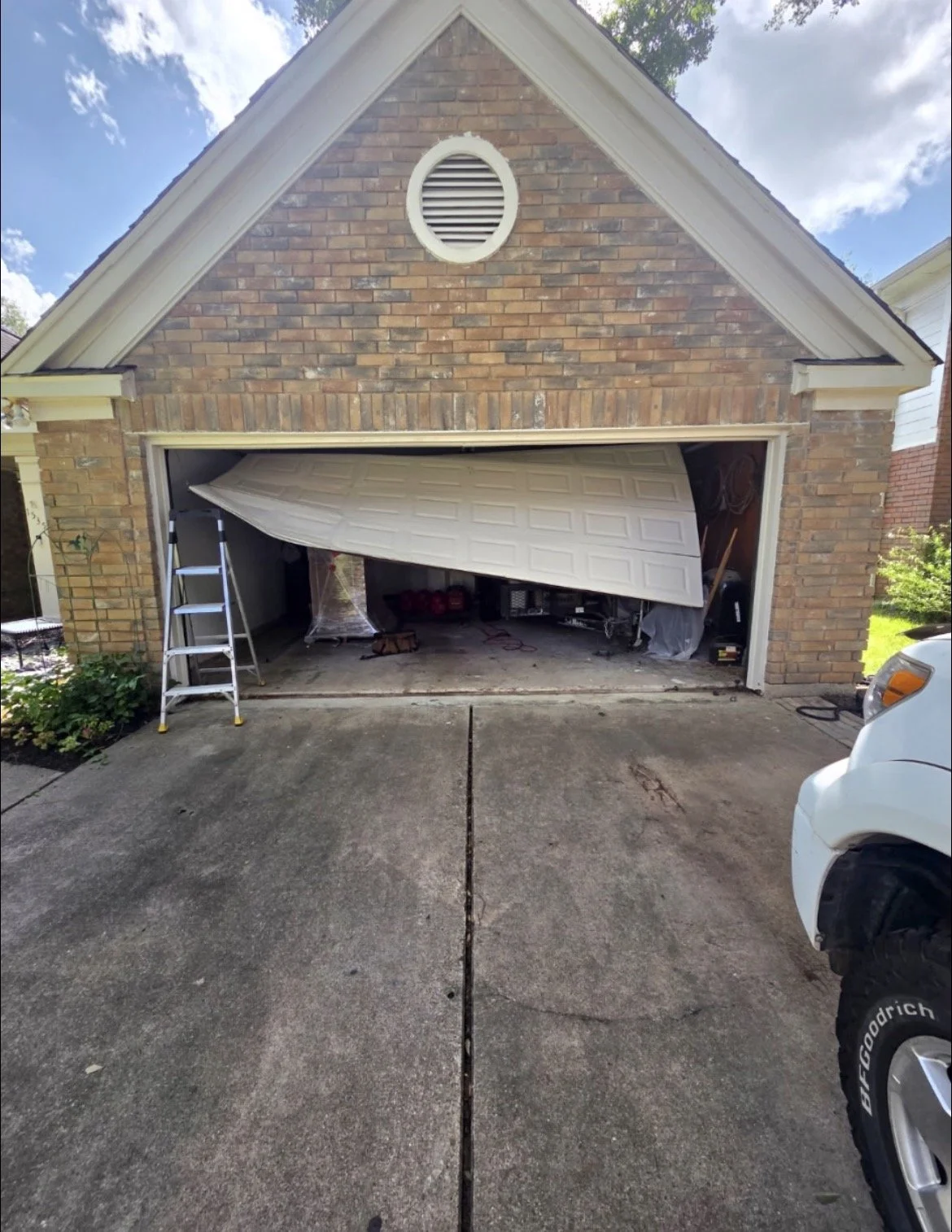 Emergency garage door off-track repair in Houston, Texas.  Legacy Garage Door LLC repaired a jammed garage door with damaged cables and restored safe operation.