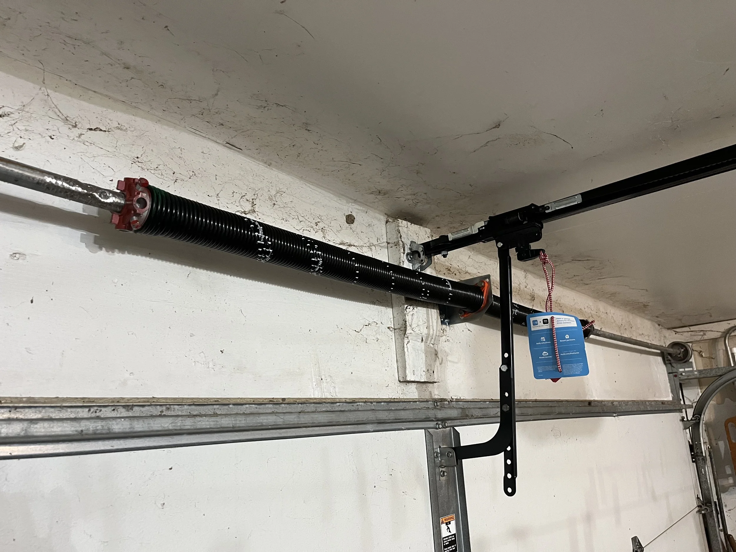 Professional broken torsion spring replacement by Legacy Garage Door LLC in Houston Texas using high-quality garage door components.