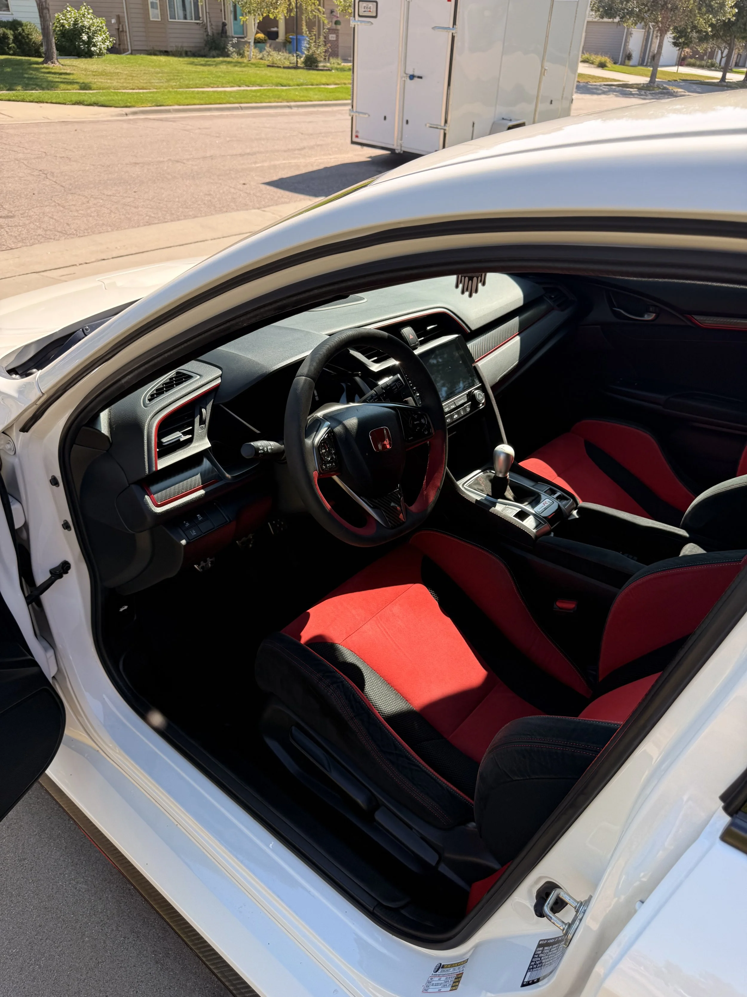 Interior detailing results showing a clean dashboard, seats, and steering wheel after professional auto detailing.