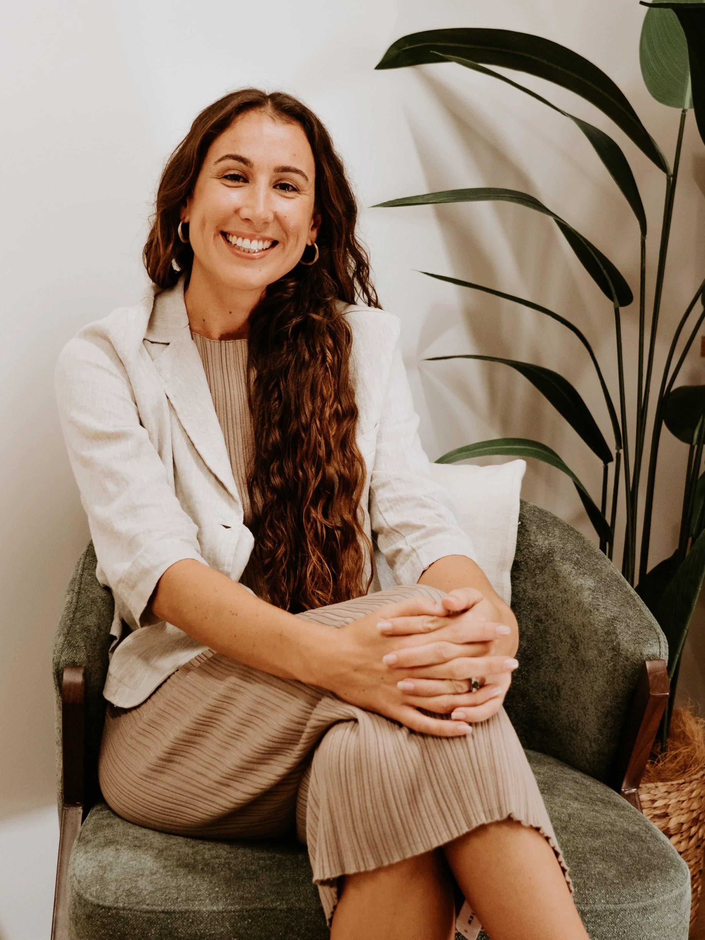 Clinical Psychologist Yasmin Miller seated in a therapy room.