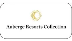 A logo with a yellow sun at the top and the text 'Auberge Resorts Collection' underneath.