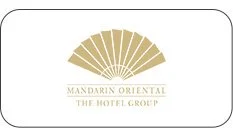 Logo of Mandarin Oriental, The Hotel Group, featuring a stylized gold fan above the name.