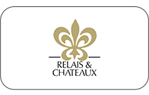 Logo featuring a gold fleur-de-lis with the text 'Relais & Chateaux' below.
