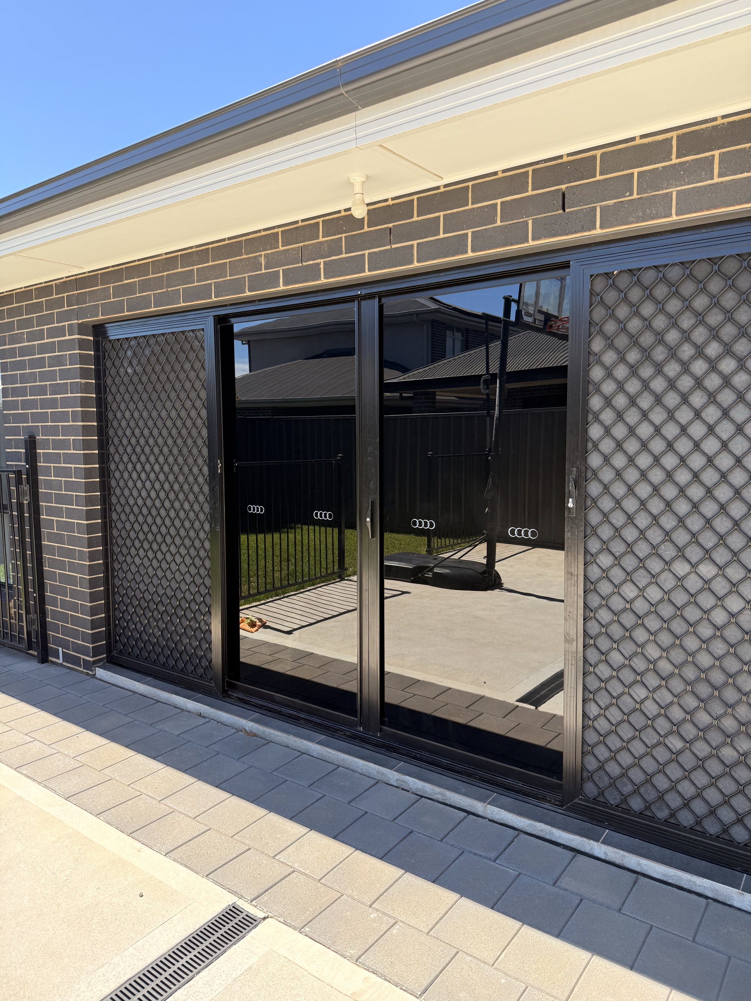 Sliding glass door window dark tinted.