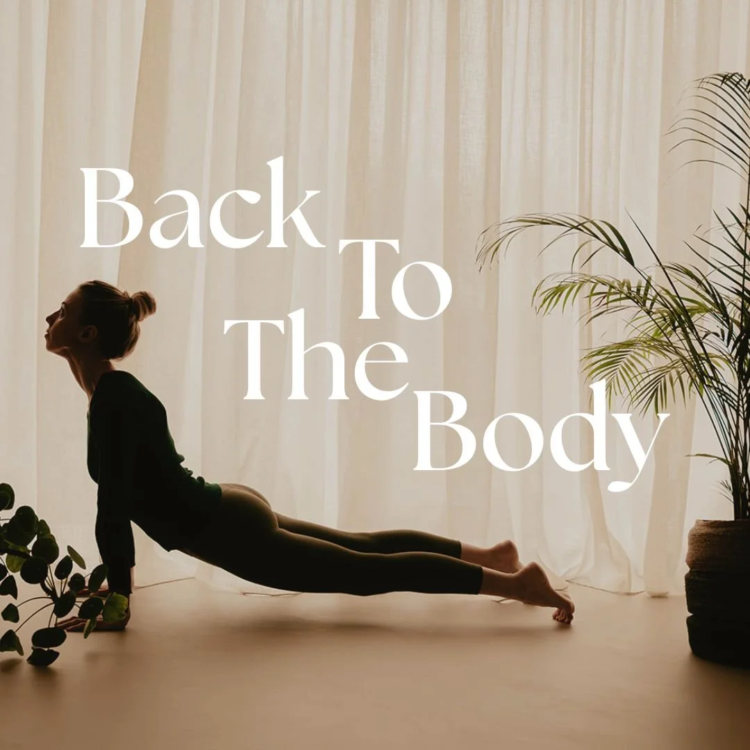 A woman practicing yoga in a home setting with sheer curtains, plants, and soft lighting. Overlaid text reads 'Back To The Body'.