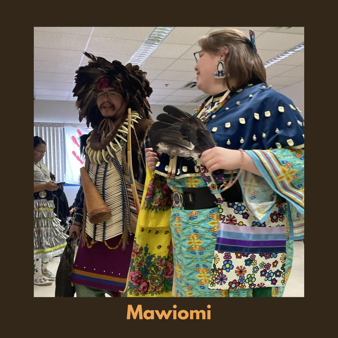 Community members dressed in traditional regalia during a Mawio’mi, participating in ceremony and cultural sharing