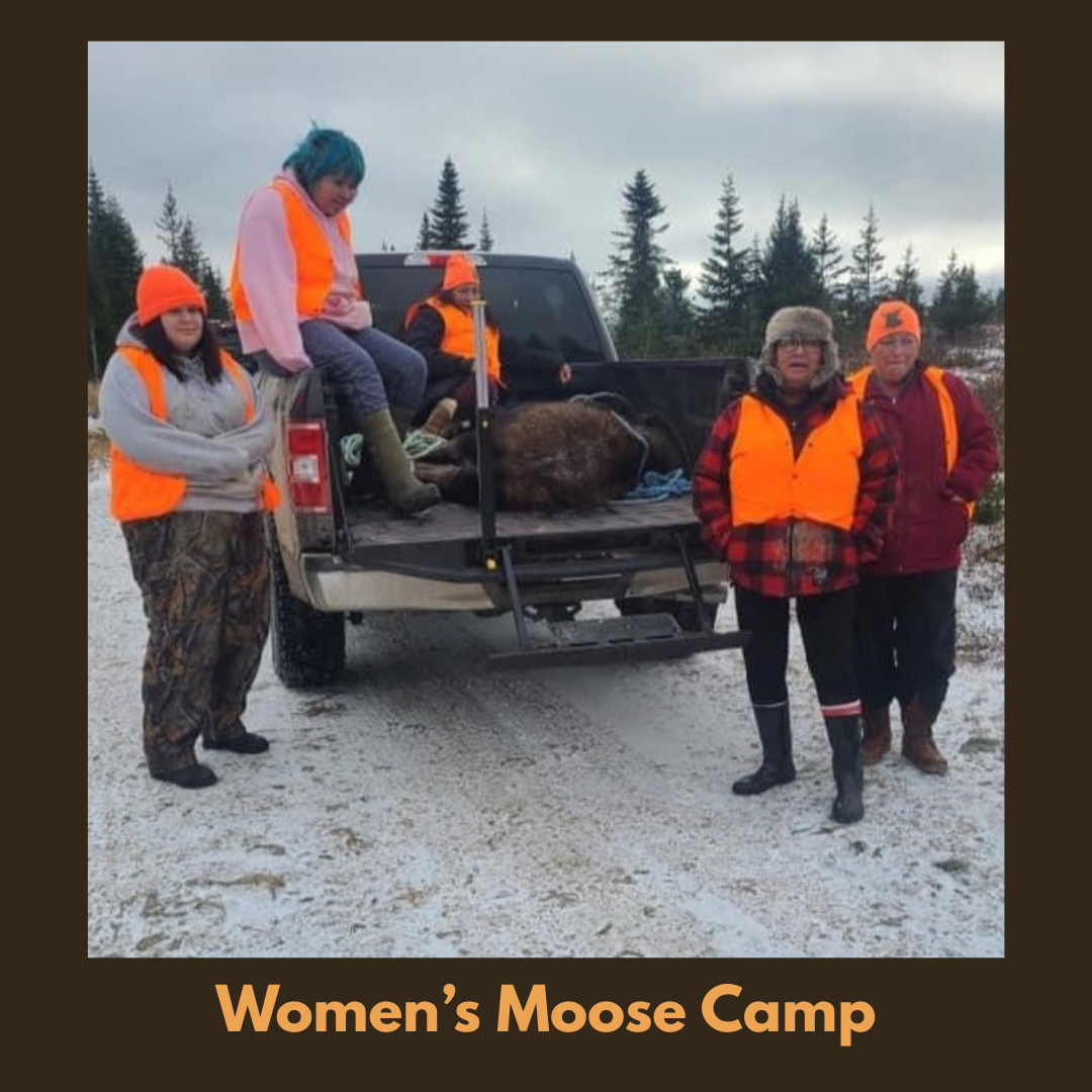 Participants gathered outdoors during a Women’s moose camp, wearing safety vests and taking part in land-based cultural learning.