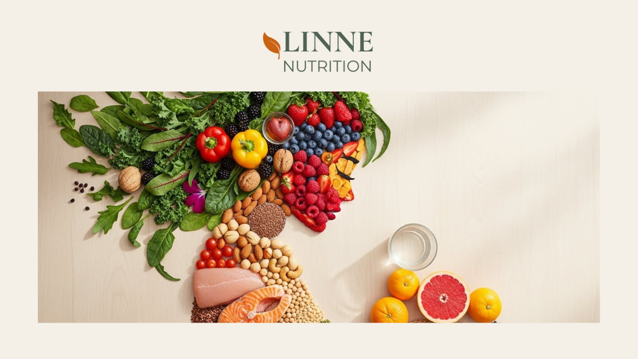 Assorted fruits, vegetables, nuts, and grains arranged on a light-colored surface with a glass of water and citrus slices at the side, over a white background featuring the LINNE NUTRITION logo.
