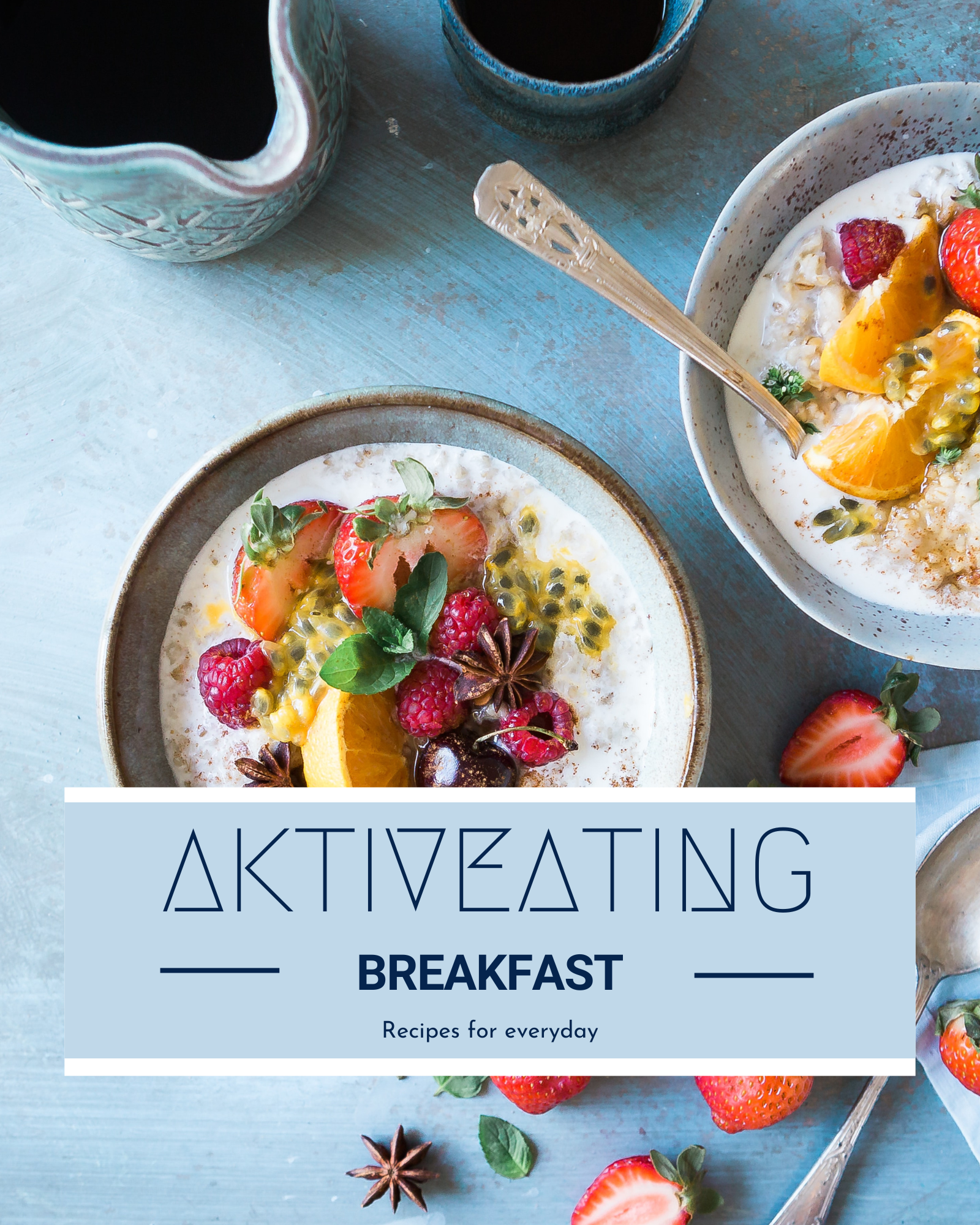 Two bowls of cereal with fresh strawberries, raspberries, passion fruit, orange slices, mint leaves, and star anise on a light blue wooden table, surrounded by extra strawberries and silver spoons