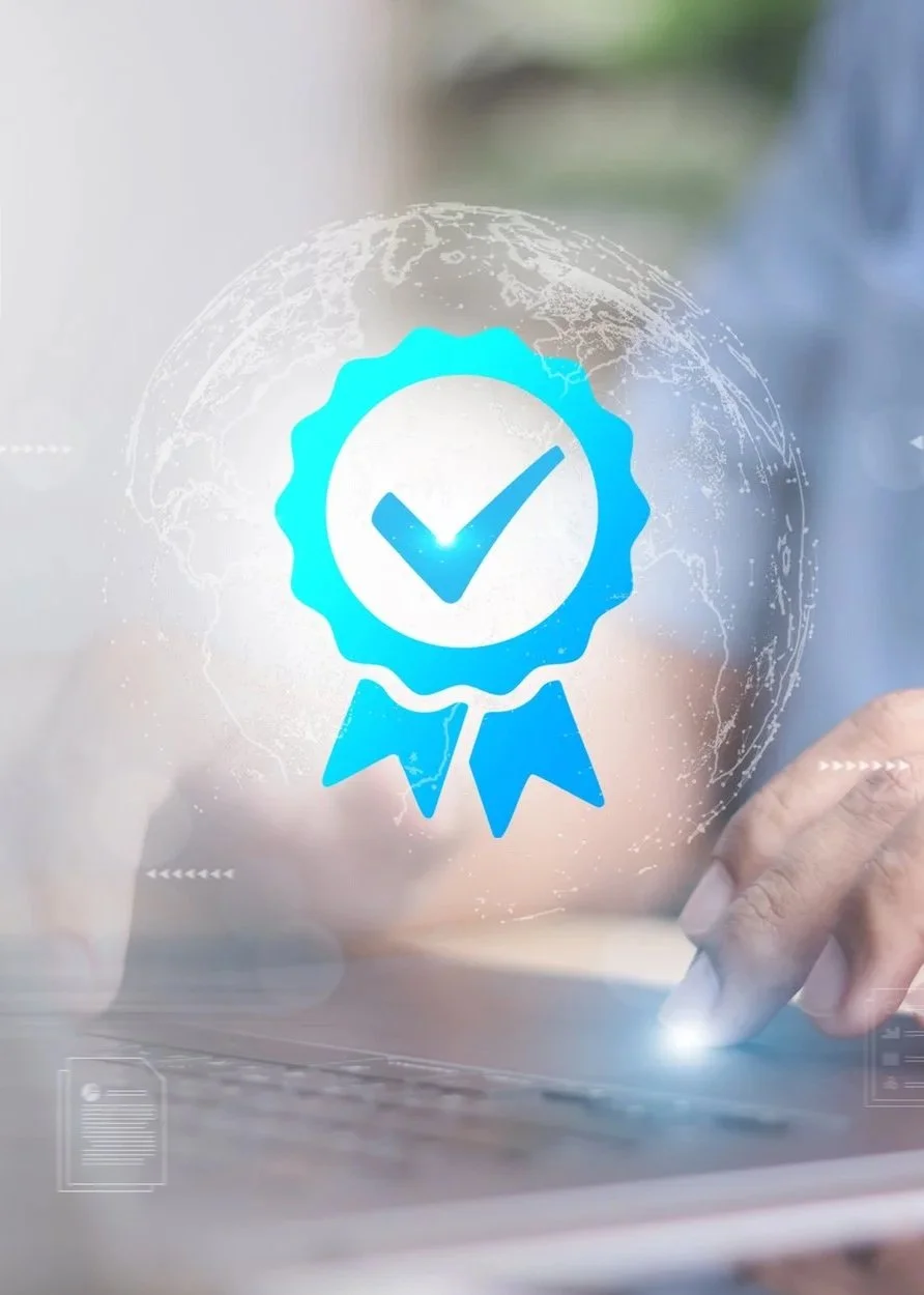 Digital illustration of a blue certification badge with a checkmark, overlaid on a blurred background of a person using a laptop.