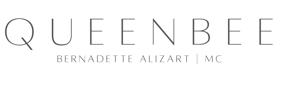 The word 'QueenBee' written in black text on a dark background.