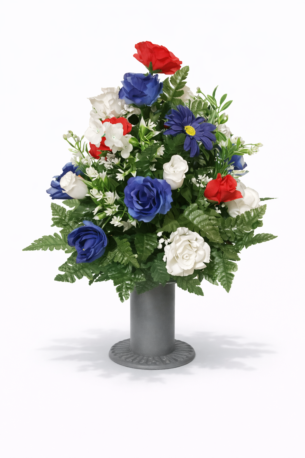 A floral arrangement with blue, red, and white flowers in a gray vase against a white background.