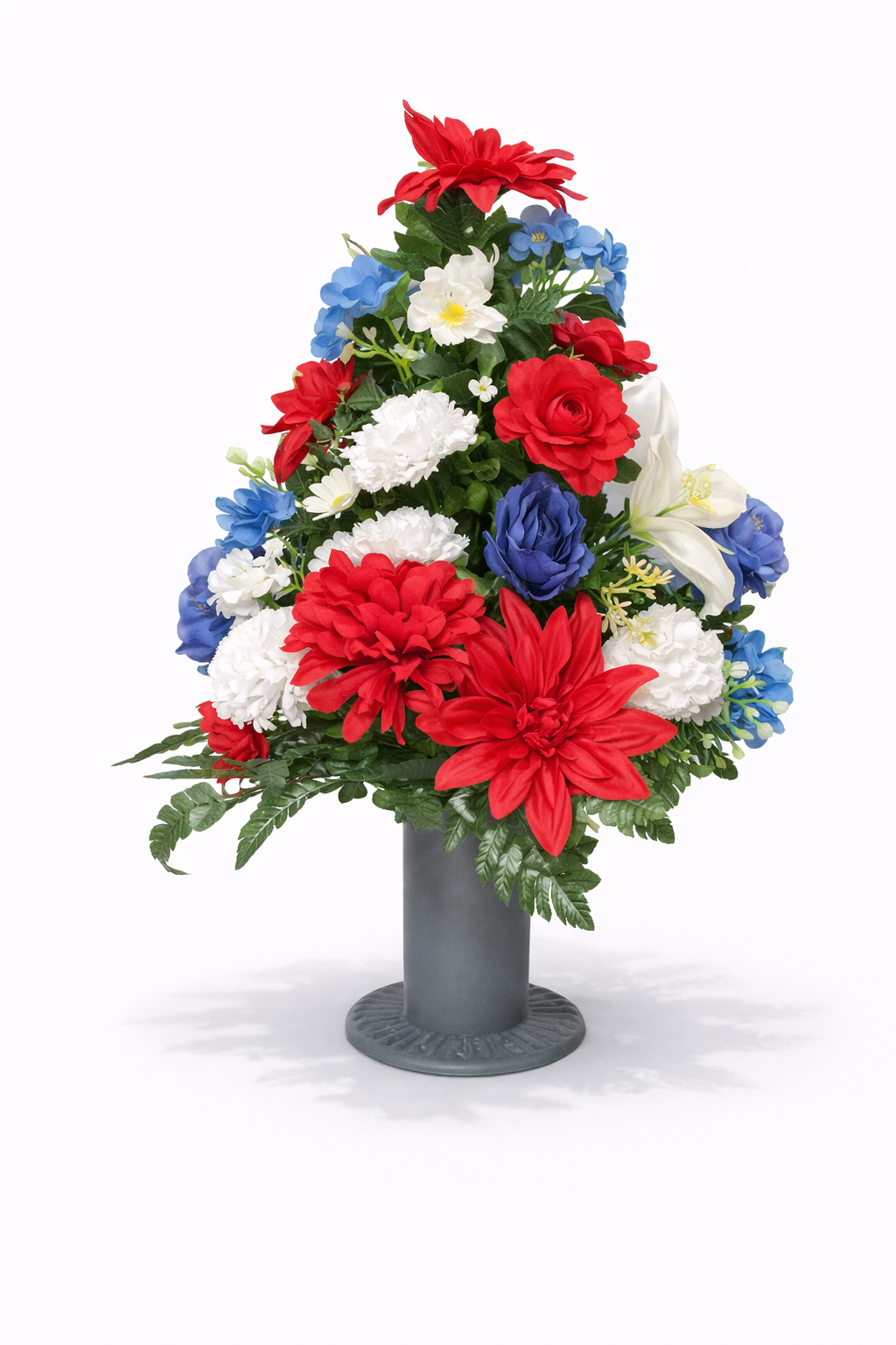 Colorful floral arrangement with red, white, blue, and white flowers in a gray vase