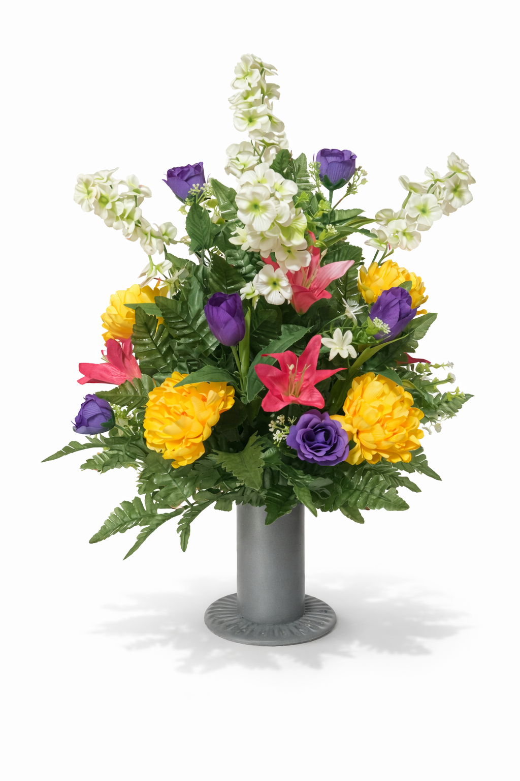Colorful artificial flower arrangement with lilies, roses, tulips, and other flowers in a gray vase against a white background.